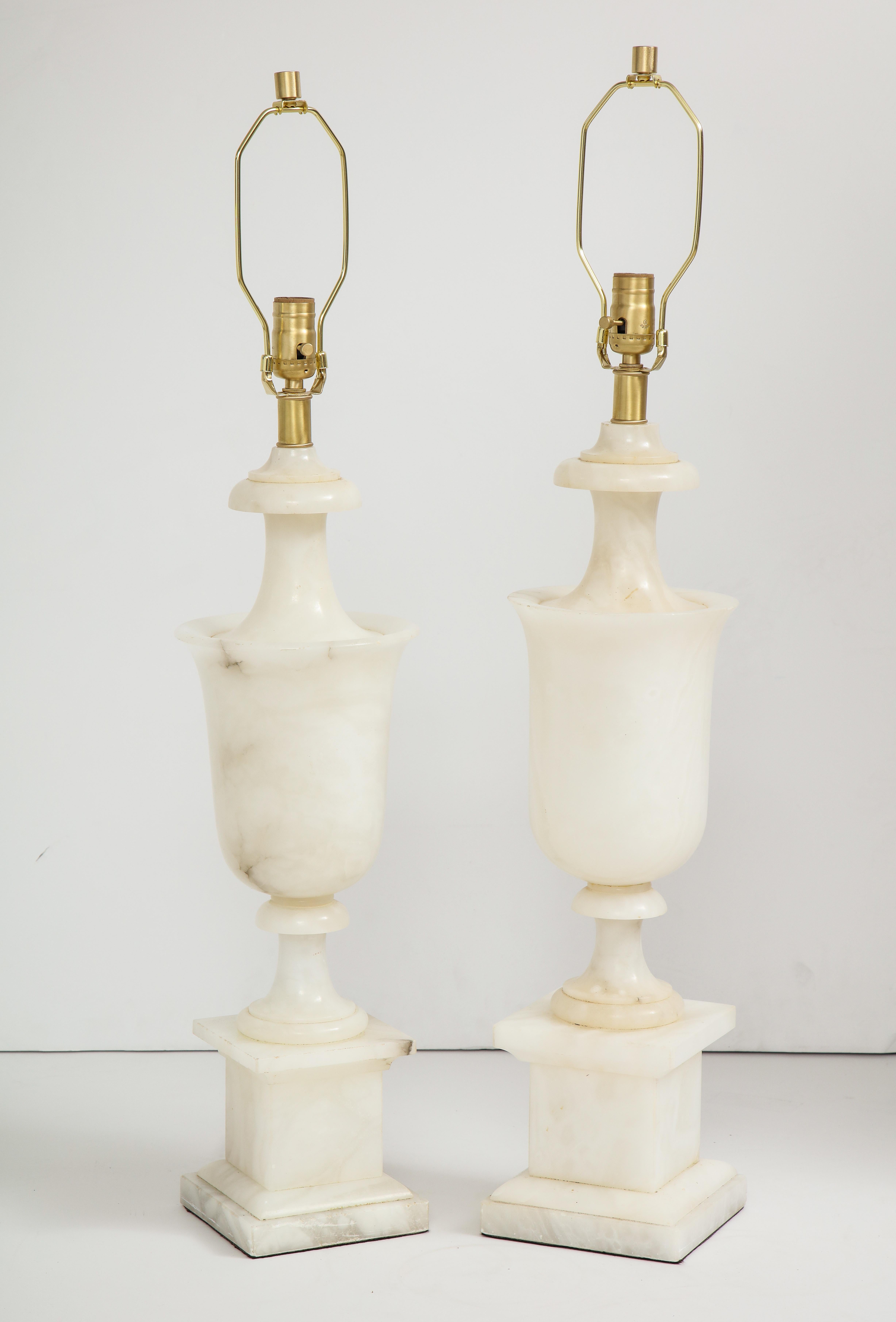 Italian neoclassical influenced handcrafted alabaster lamp features an urn shaped body resting on square platform base, all in a milky white alabaster with slight grey/gold veining. Rewired for use in the USA, 100W max bulb.

Only 1 available.