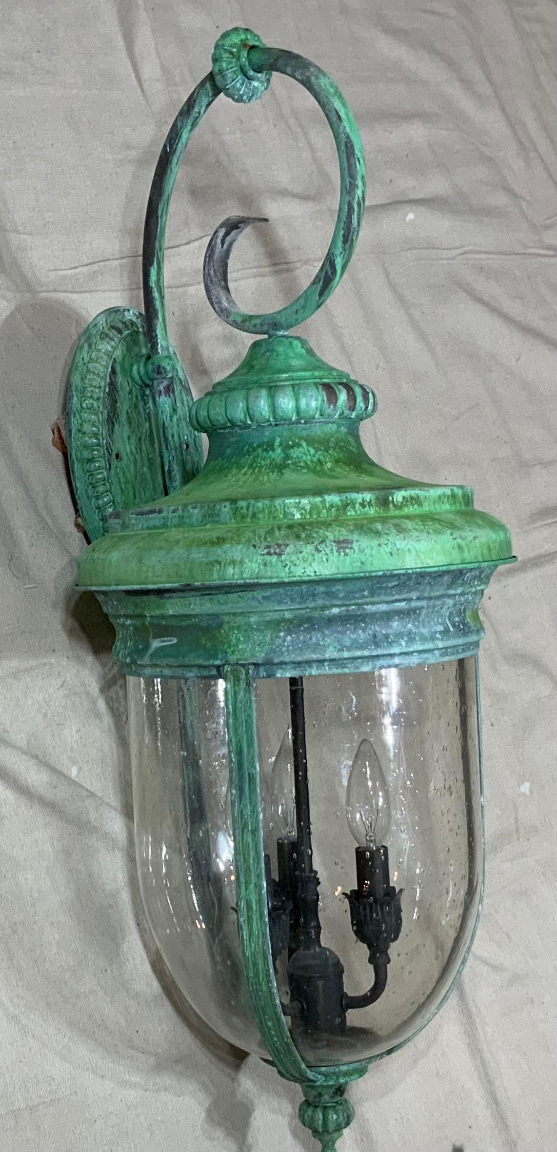Exceptional single large wall lantern made of solid copper-brass , quality workmanship, electrified with three 40/watt light each, beautiful seeded glass. Great light exposure.
Suitable for wet location. 
Great patina decorative pair of lantern