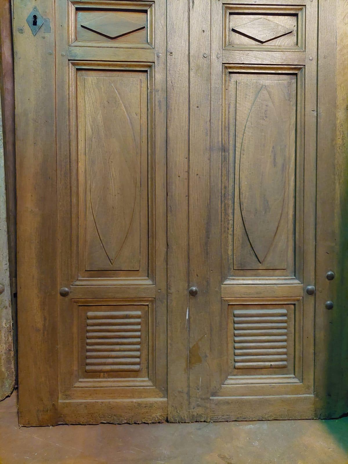 Antique Entrance door, single-leaf main door, elegantly hand-carved in precious solid walnut wood, carved with almond shapes typical of northern Italy, 19th century, push opening to the right, originally it was a double door swing, later reconverted