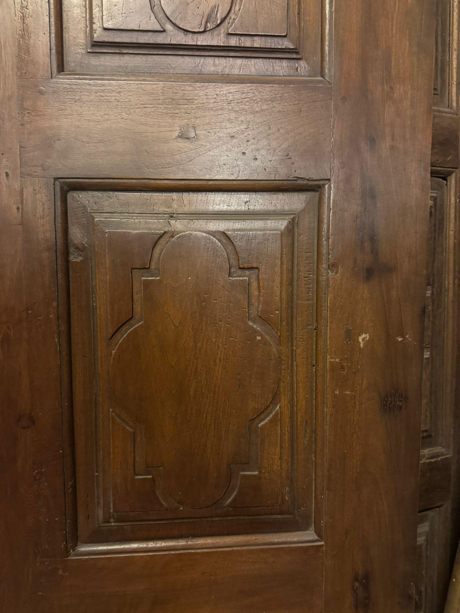 Antigua puerta de interior de una hoja, con 3 hojas talladas con motivo geométrico barroco, construida en madera maciza de nogal, trasera lisa y sin bisagras, por tanto con posibilidad de hacer la apertura necesaria y también corredera si se desea,