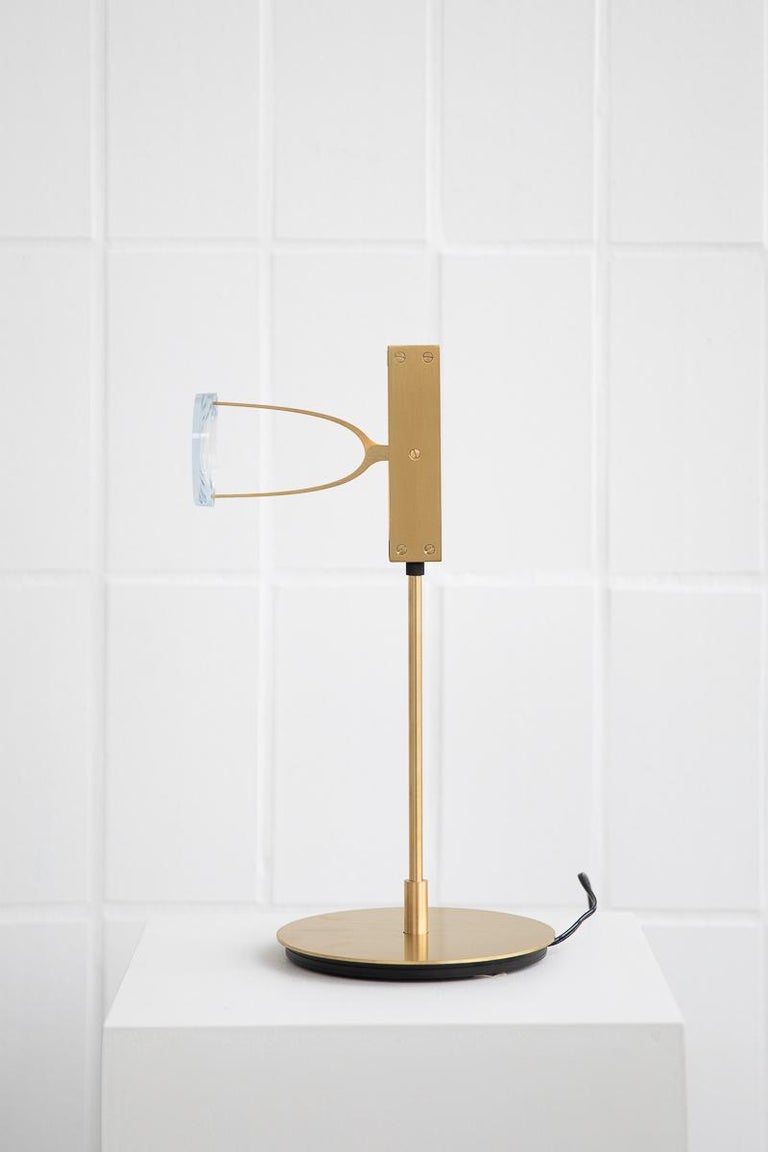 Single Lens table lamp by Object Density
Handmade
Dimensions: Ø16 x 34 cm
Material: Brass (Messing), Optical lenses, Dimmable 12V LED

Through a close inquiry into an optician’s process and production, Object Density have realised the
