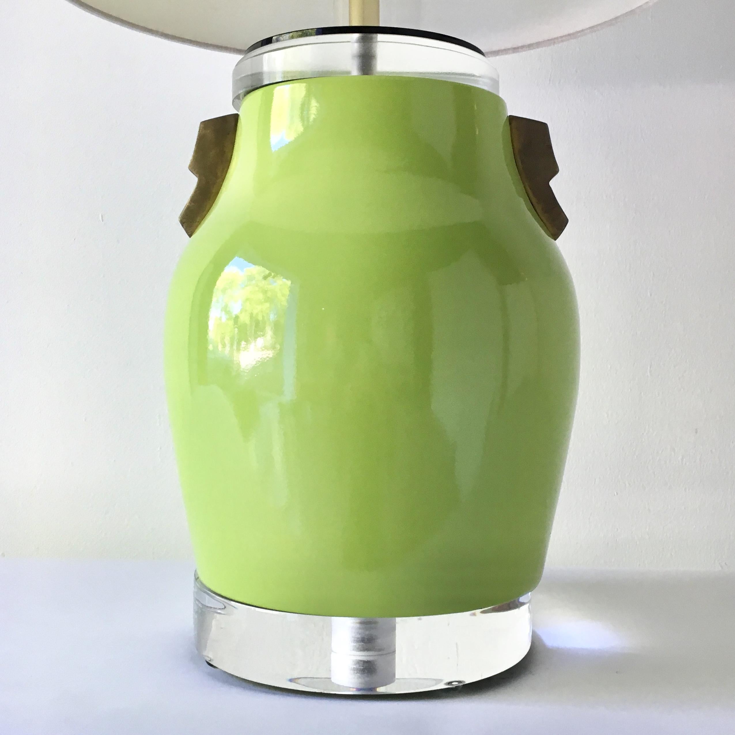 A single lime green glazed ceramic table lamp with patinated brass and Lucite details, 1980s.

 