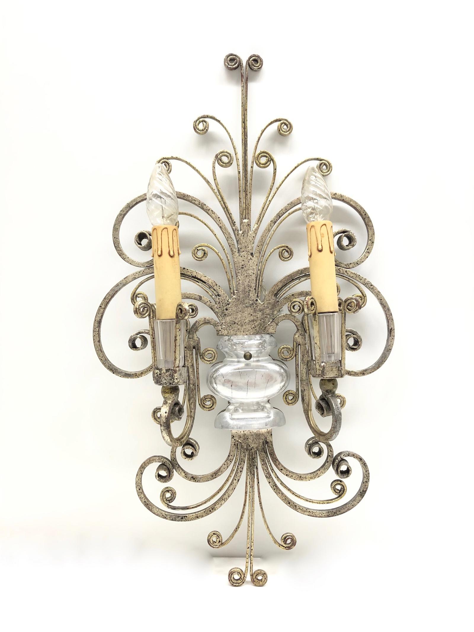 A single silver tone iron floral sconce by Banci Firenze with crystal urn motif, socket cover also made of crystal glass. The fixture requires two European E14 candelabra bulbs, each bulb up to 40 watts. The wall light has a beautiful patina and