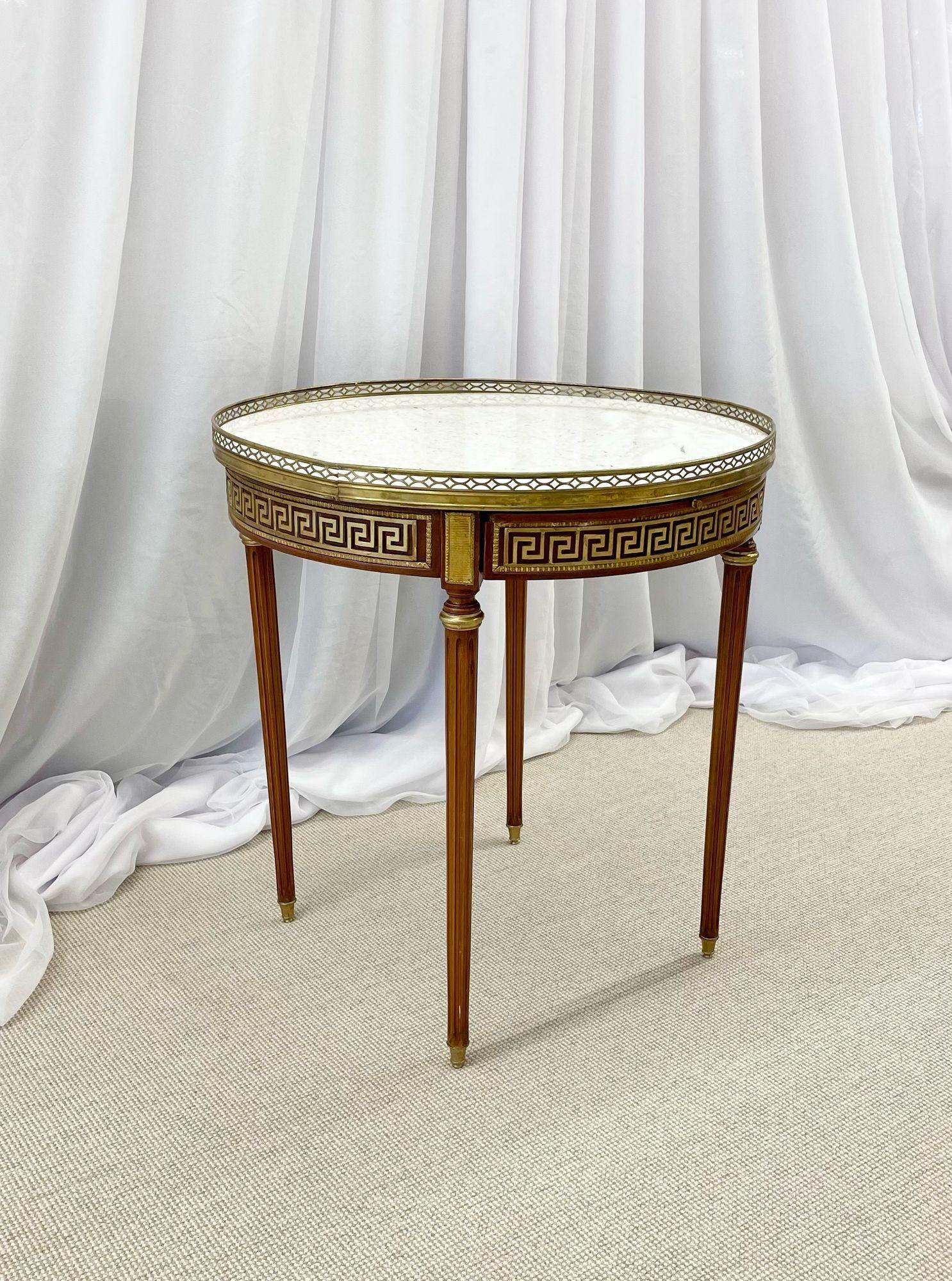 Single Marble Top Greek Key Bouillotte or End Table, Manner of Maison Jansen
A marble top Greek Key Bouillotte or end table. Manner of Jansen in mahogany with double drawers and pull-out slides. Each bronze sabot leading to a group of tapering legs