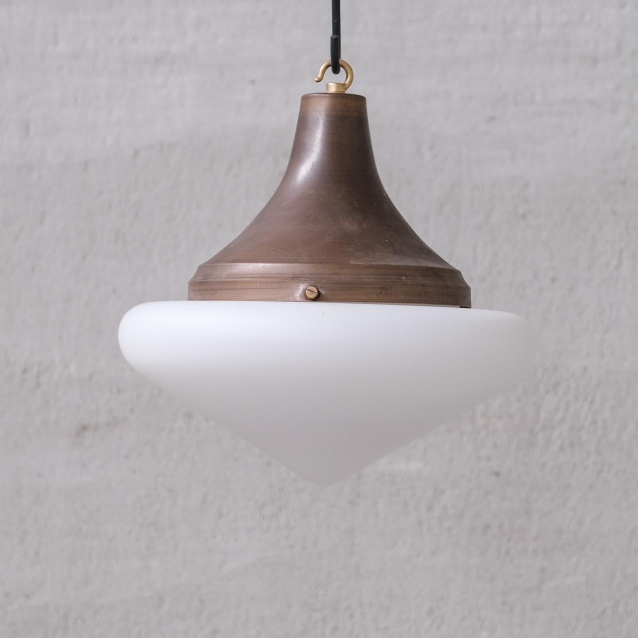 A single elegant opaline pendant, in matt glass finish.

France, c1950s.

Paired with a metal gallery that looks to be naturally patinated brass or similar.

No chain or rose was retained, however they are easy to source online.

Good vintage