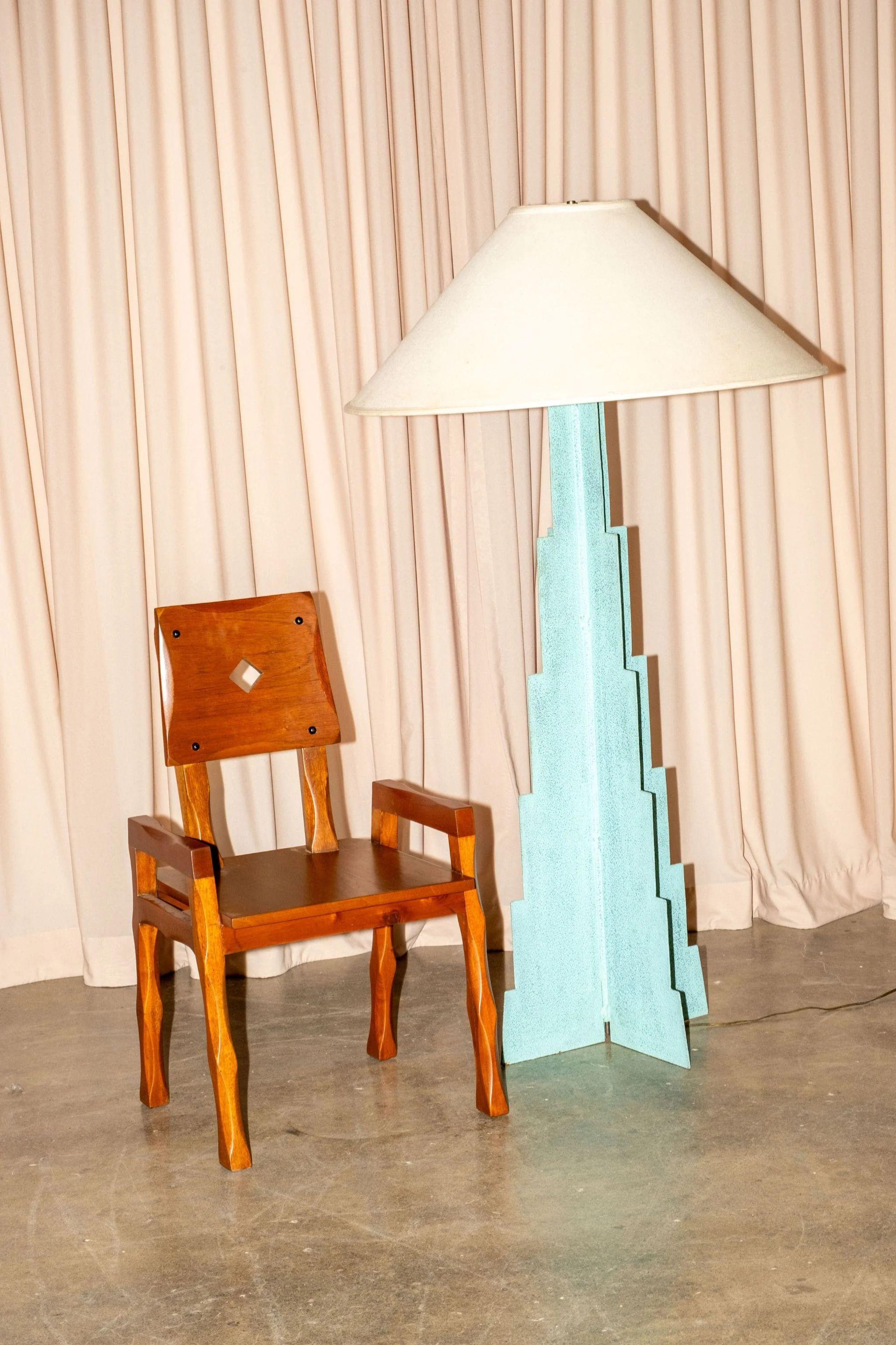 The midcentury modern armchair, likely of Mexican origin, boasts a captivating blend of rustic charm and refined simplicity. The rich, warm tones of the wood are striking, its grain subtly visible. Notice the unique, almost sculptural, shaping of