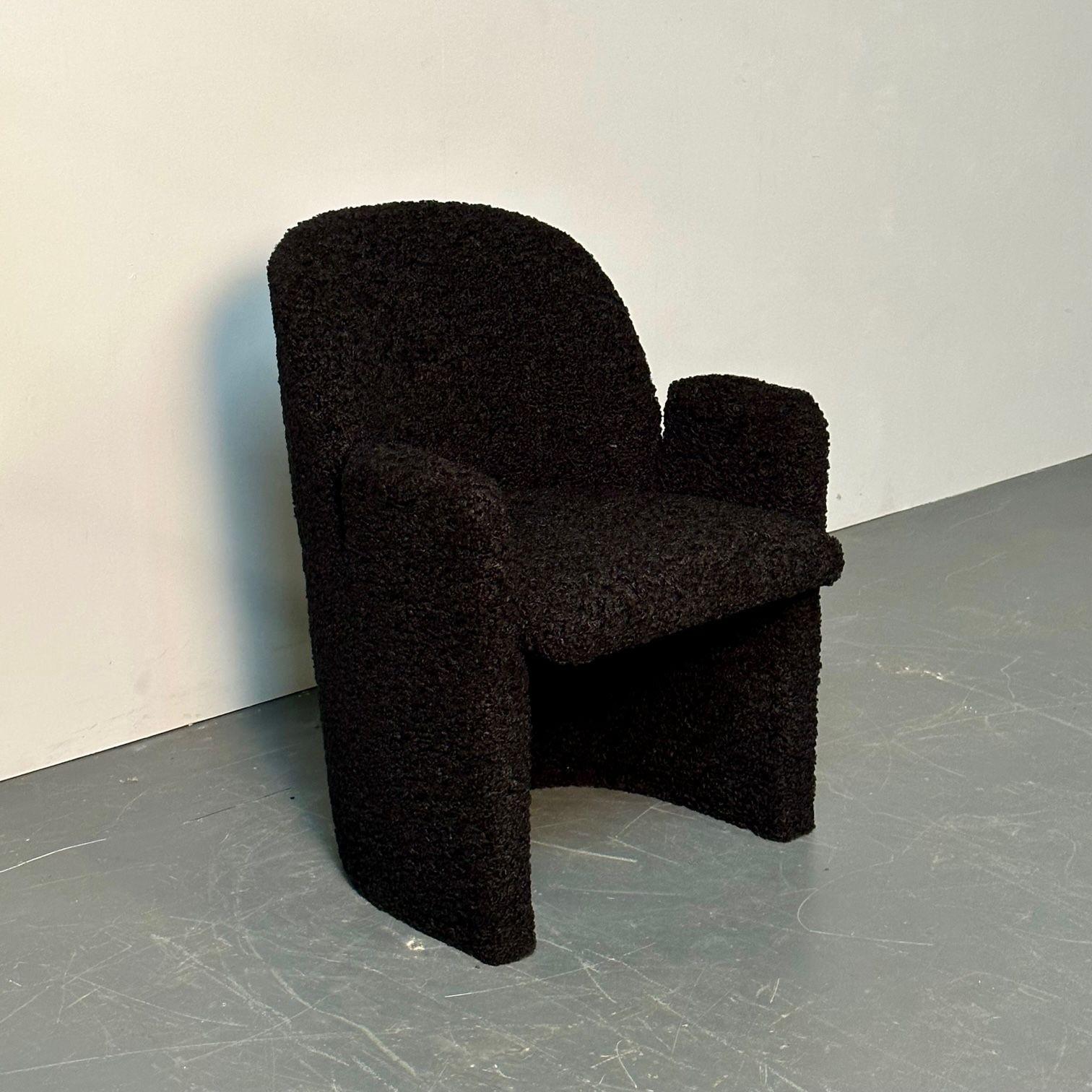 Single Mid-Century Modern style arm / lounge chair, black bouclé, organic form
 
Contemporary arm, accent, or lounge chair newly upholstered in a luxurious black bouclé fabric. The chair has a slightly titled backrest and upholstered arms for