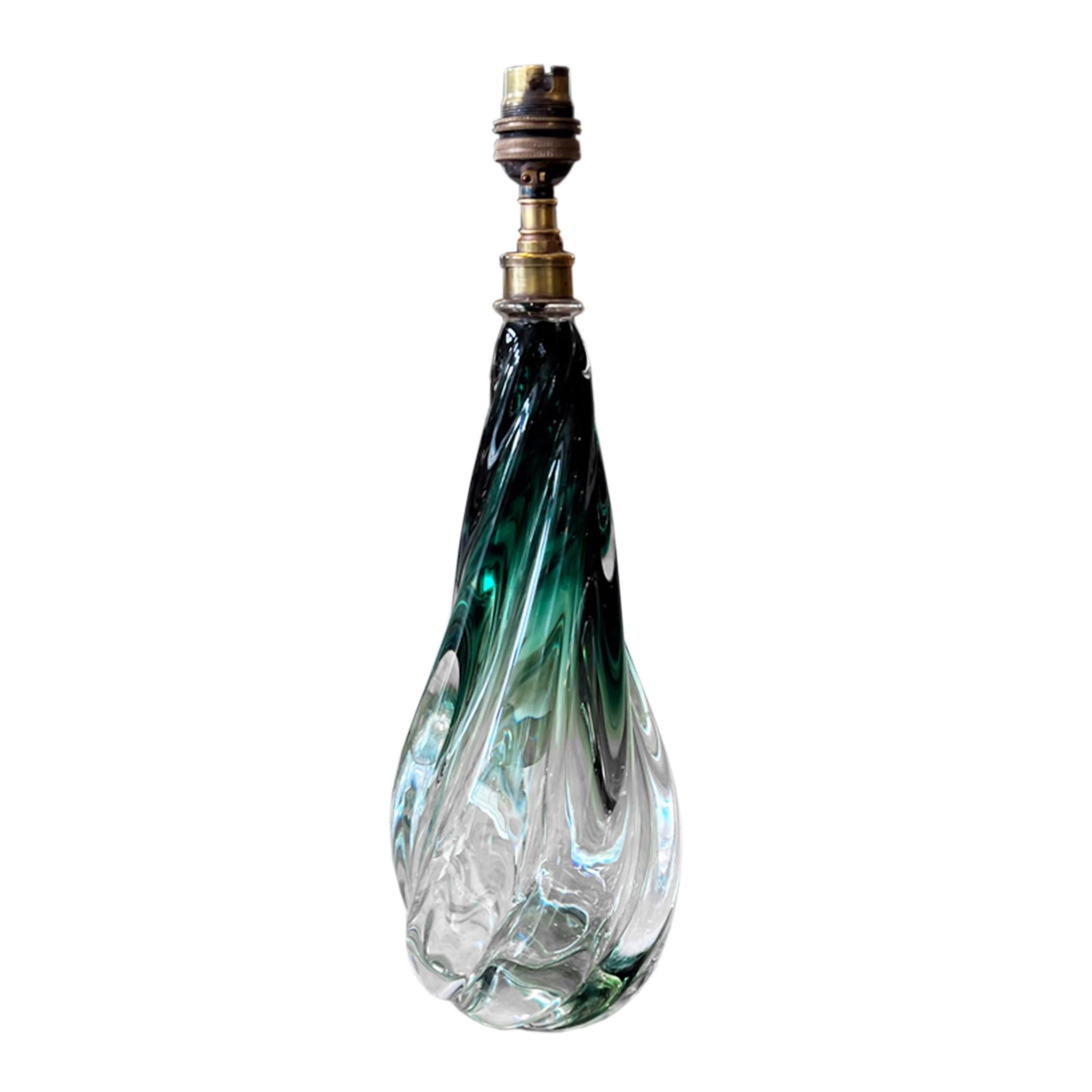This single midcentury green and clear glass table lamp is by the luxury Belgian brand Val Saint Lambert. 

Please take a look at all our pictures to see how the green glass fades to clear, with the swirling design. It also retains the original