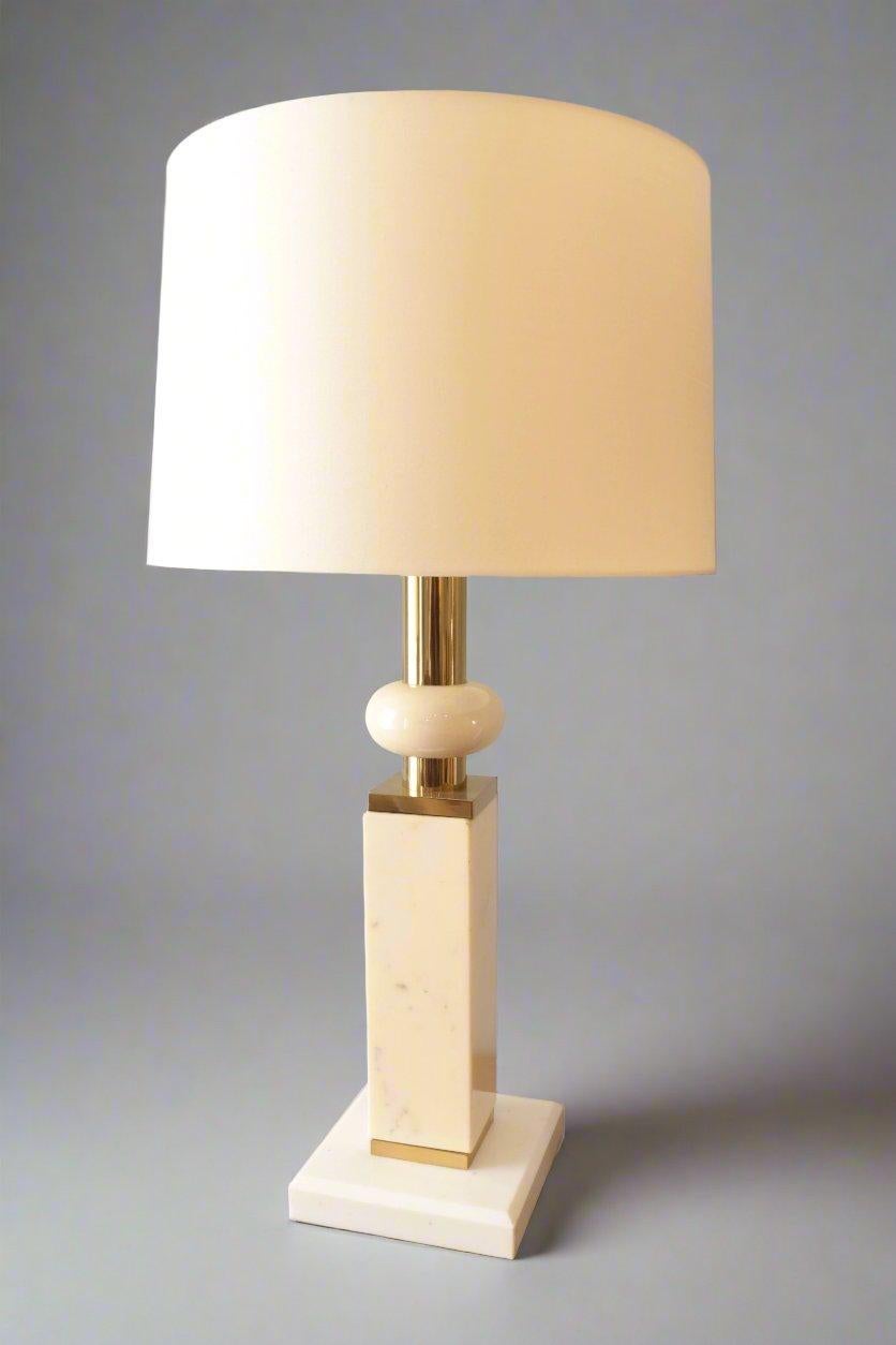 A Modernist marble table lamp. 
White and ivory colored marble 
with patinated brass details.