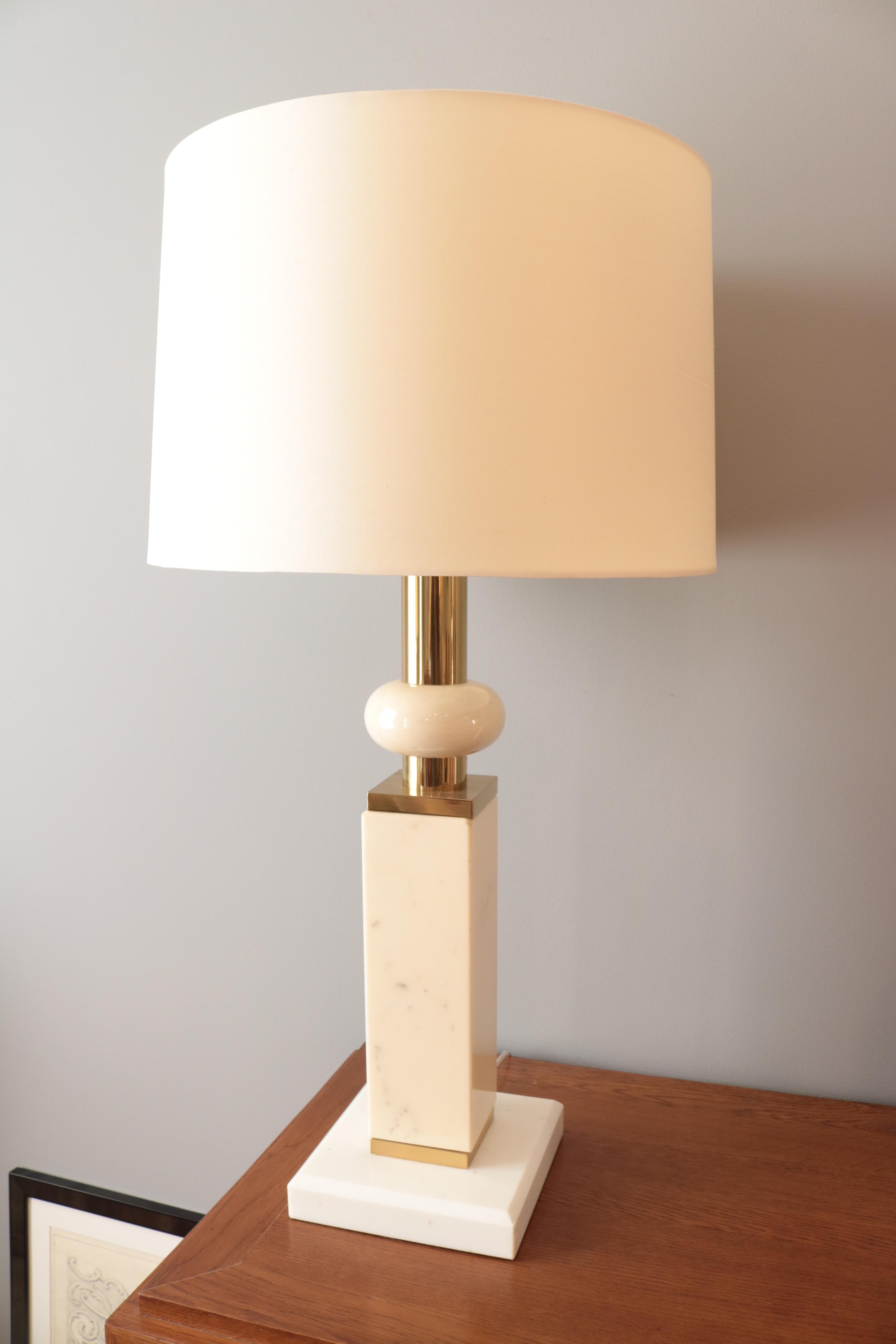 A Modernist marble table lamp. 
White and ivory colored marble 
with patinated brass details.