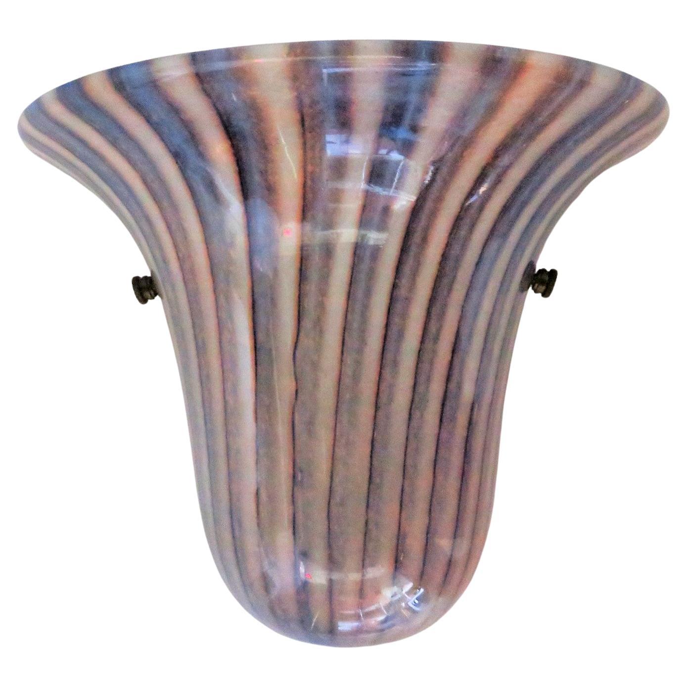 The subdued colors of this single Murano Glass Sconce would be very elegant in any home decor.  With an upside down half bell shape form and an blown glass spray of pinks and gray-blue color stripes terminating in an opening at the bottom, its
