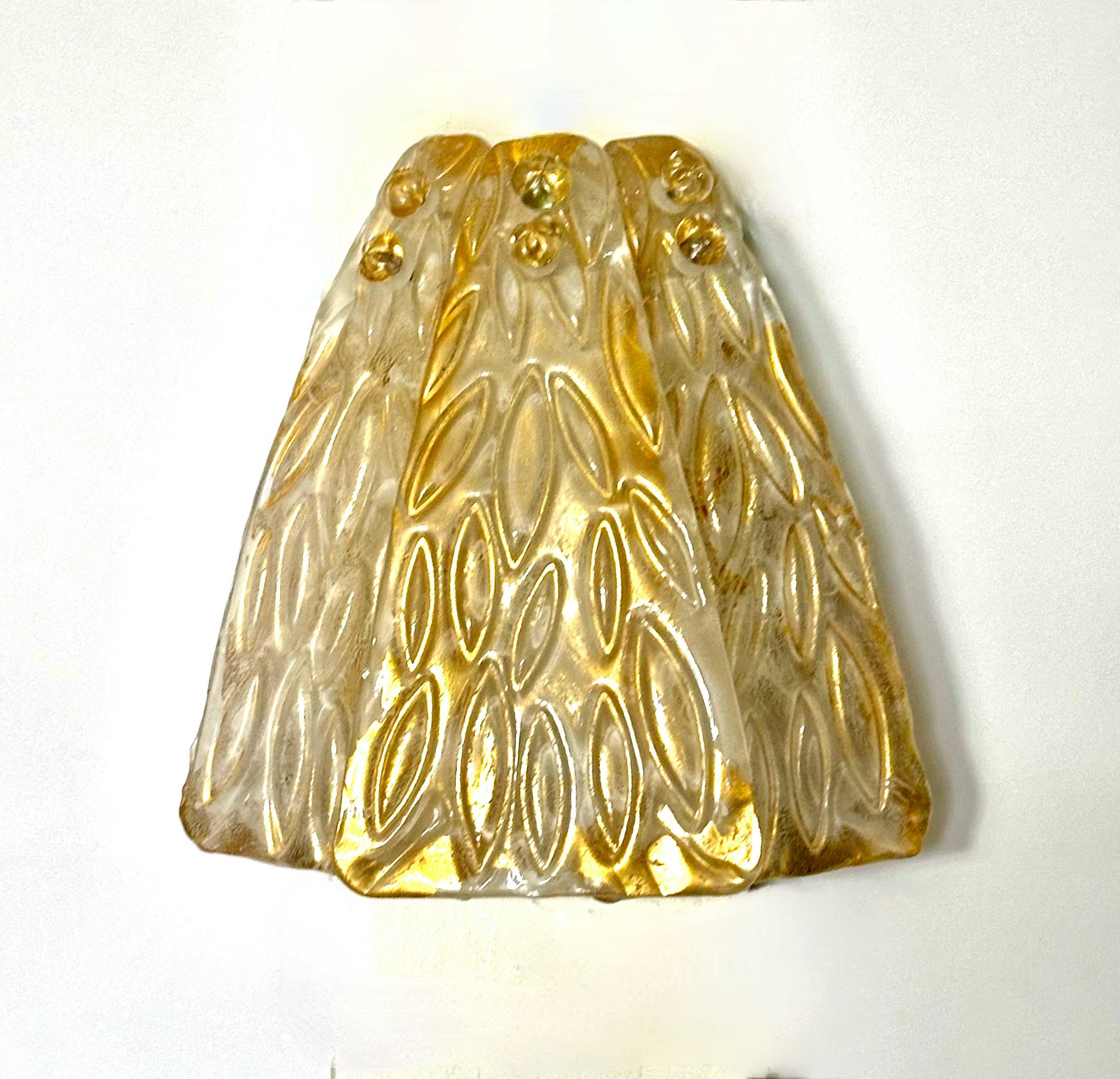 One single hand blown clear and gold surface inclusions glass leaf shaped wall sconce, supported on white metal backplate. Reverse side of the 3 glass leaves is a matte textured surface that diffuses light. Uses 2 candelabra size bulb.