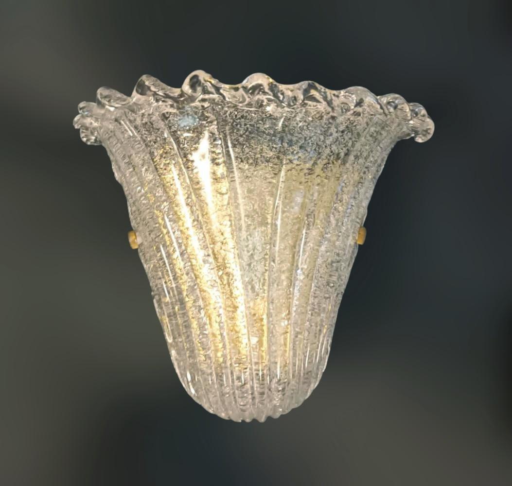 Italian wall light with a Murano glass shield hand blown in Graniglia technique to produce granular textured effect, mounted on gold frame / Made in Italy circa 1970s
Measures: Height 9.5 inches, width 11 inches, depth 5.5 inches
1 light / E26 or