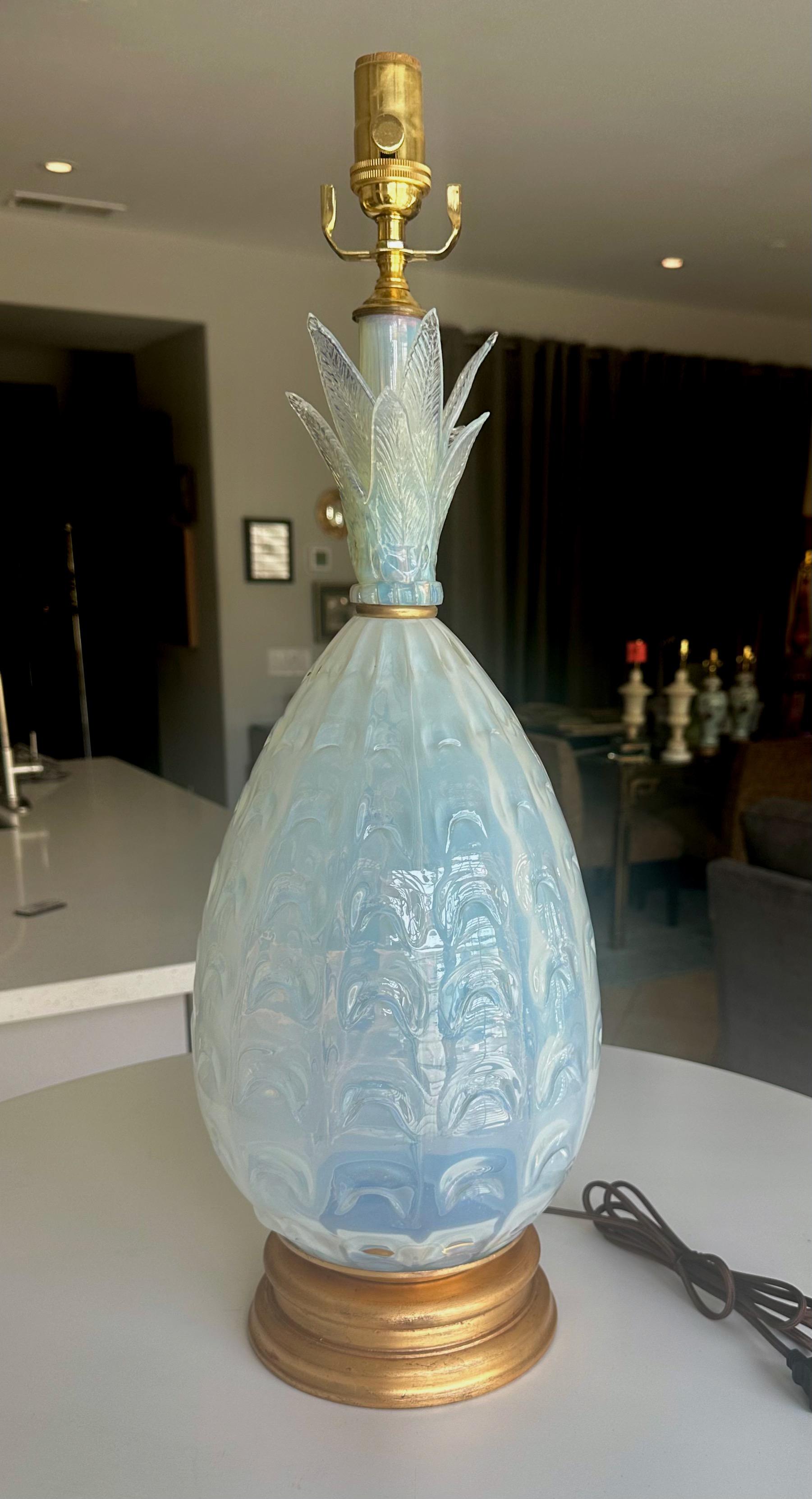 A mid century single pineapple shape Murano Italian pale blue opalescent glass table lamp. Mounted on a giltwood base. Newly wired with a brass 3 way socket and rayon cord. Overall height of lamp is 286
