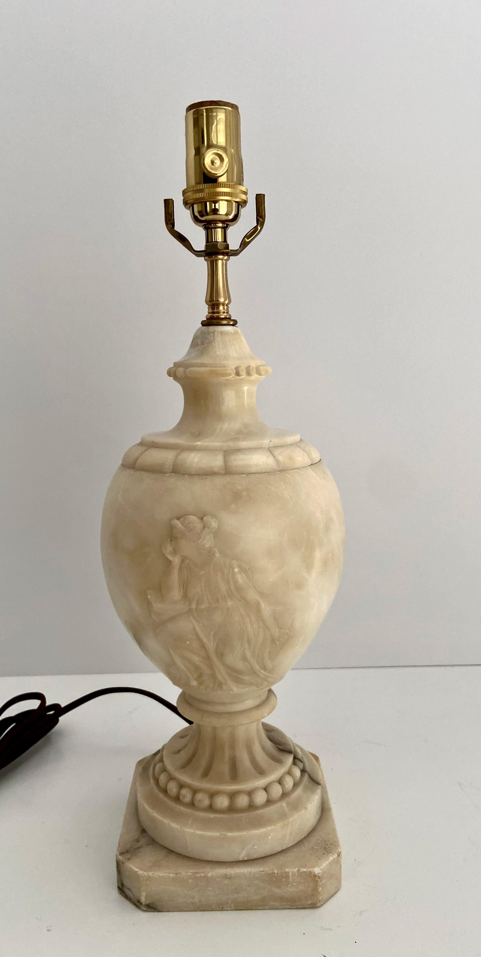 Single finely crafted hand carved neo-classic style urn form alabaster lamp with intricately carved relief grecian women. Newly wired with 3 way socket and rayon covered cord.
Height to top of alabaster is 13.5