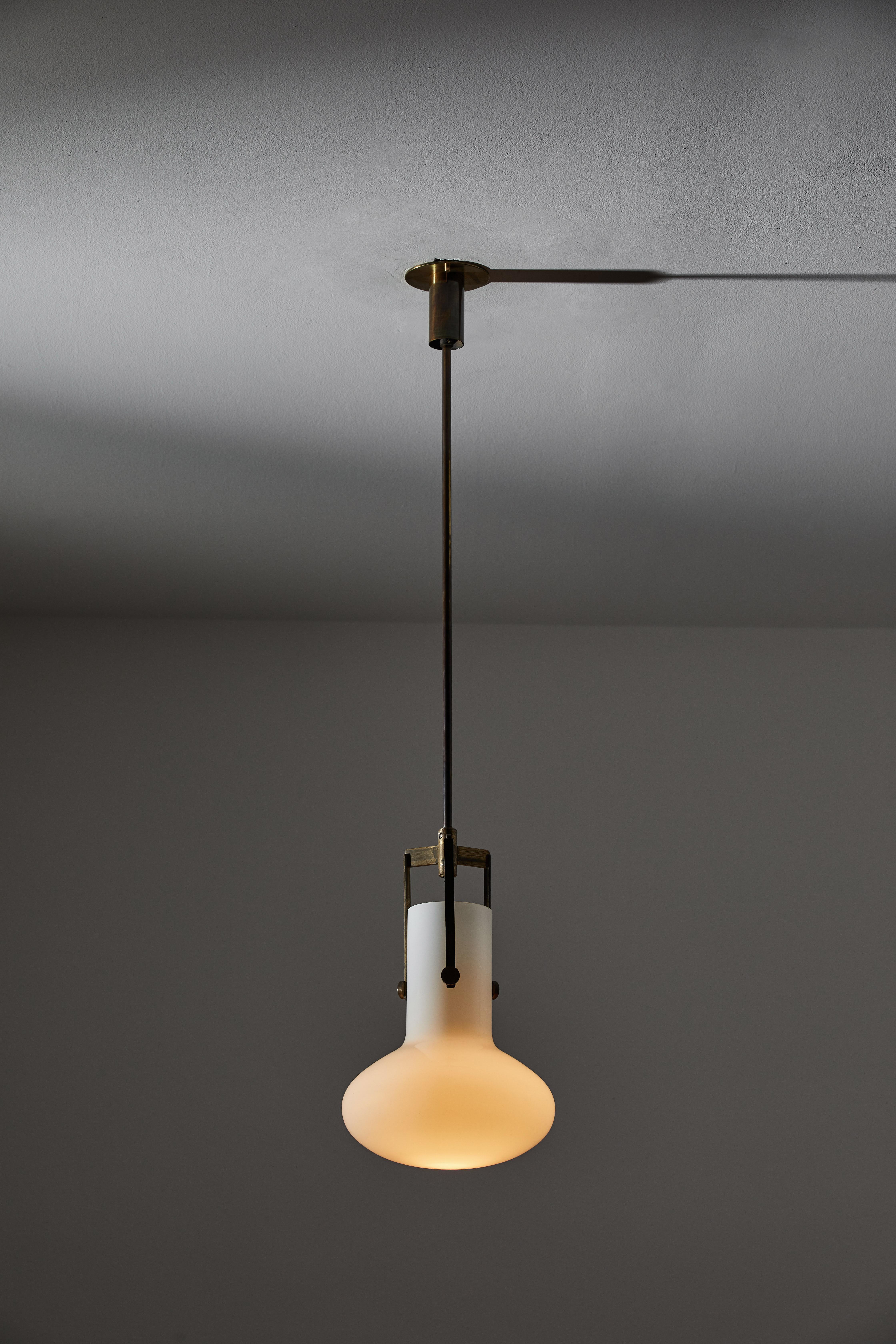 Single Pendant by Venini. Designed and manufactured in Italy, circa 1960's. Opaline glass, brass. Wired for U.S. standards. Custom brass ceiling plate. We recommend one E26 75w maximum bulb. Bulbs provided as a one time courtesy. Overall drop can be