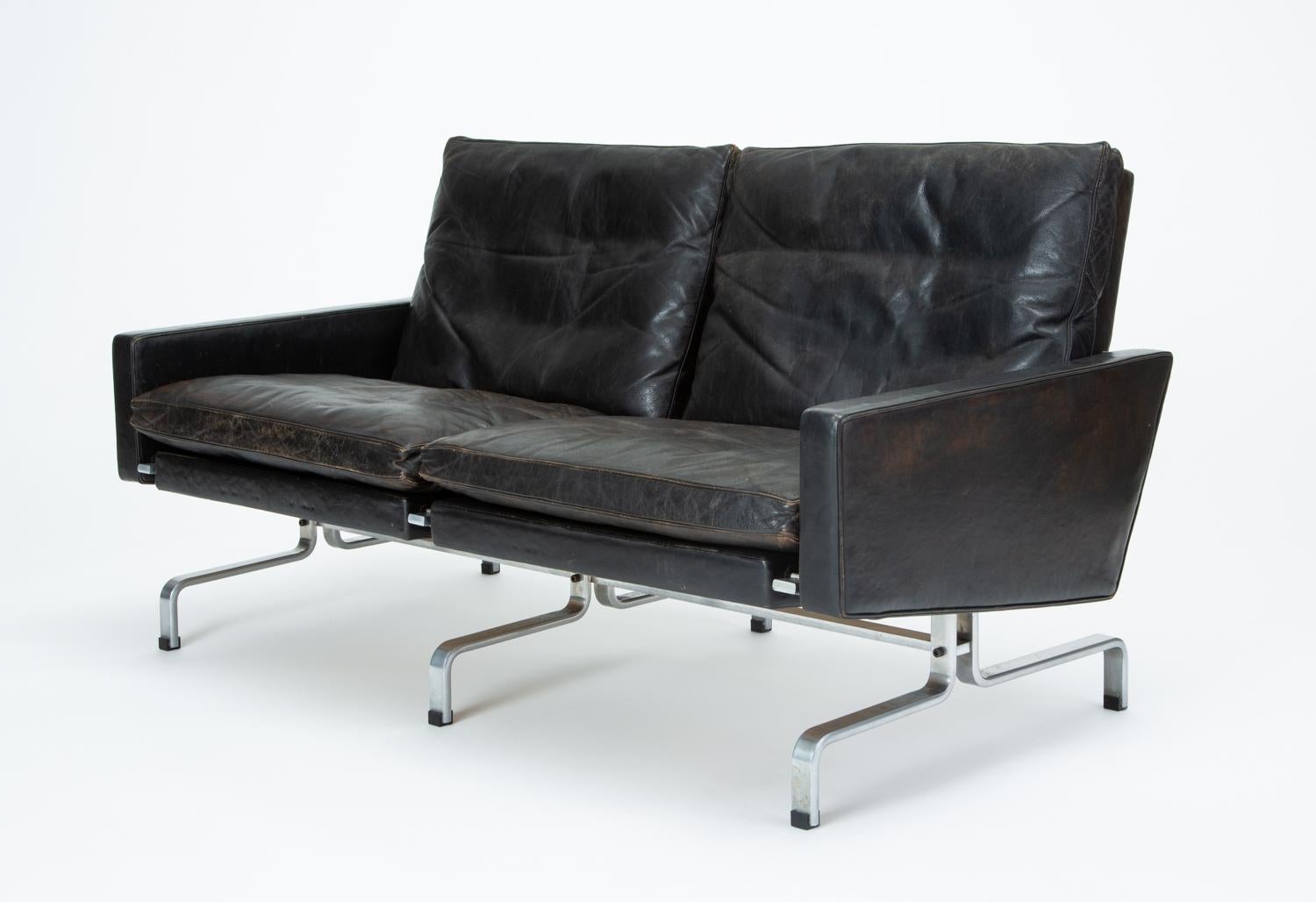 Poul Kjærholm's PK 31 seating series was envisioned as a discrete unit (the frame was designed to conform to the walls of an invisible cube) that could be multiplied to suit any use through simple repetition. This PK 31/2 love seat comprises of two