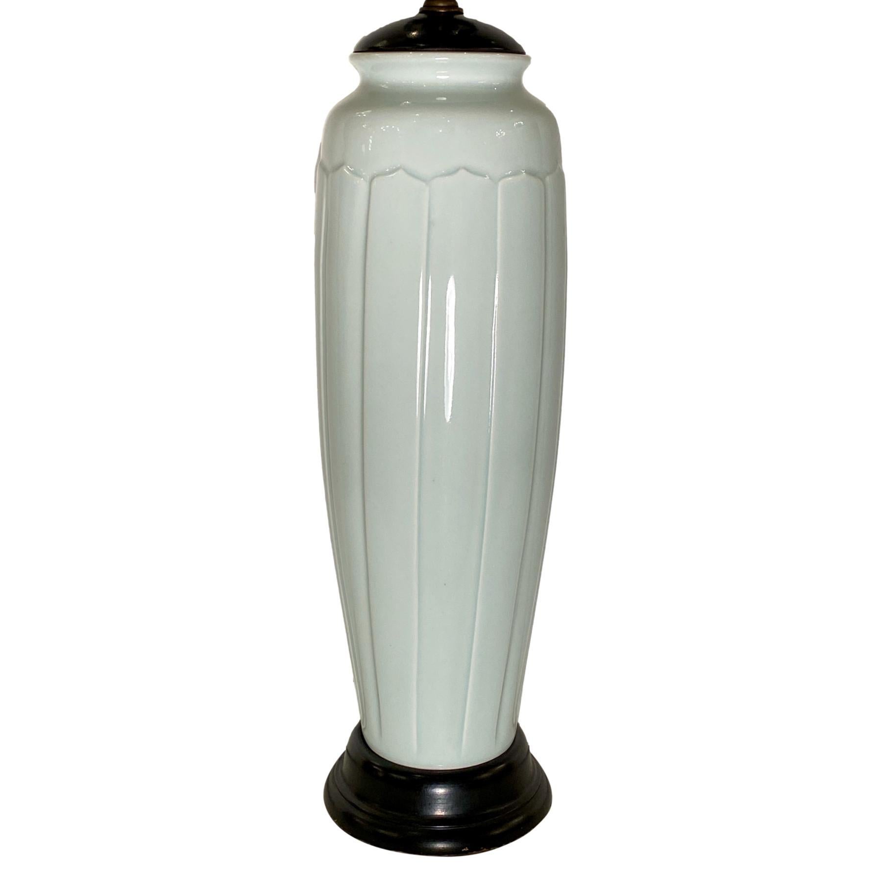 A circa 1940's French porcelain table lamp with wooden base.

Measurements:
Height of body: 16.5
