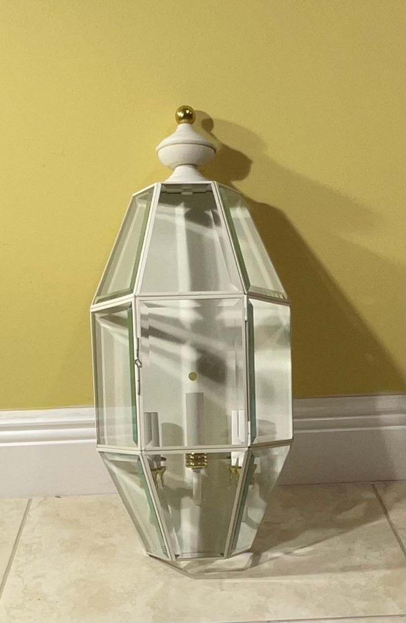 Single outdoor light in  a contemporary geometric style handcrafted from solid brass power coated in decorative white color thick beveled glass  ample three 40/watt lights great light exposure 
Up to US code. Ready to use .