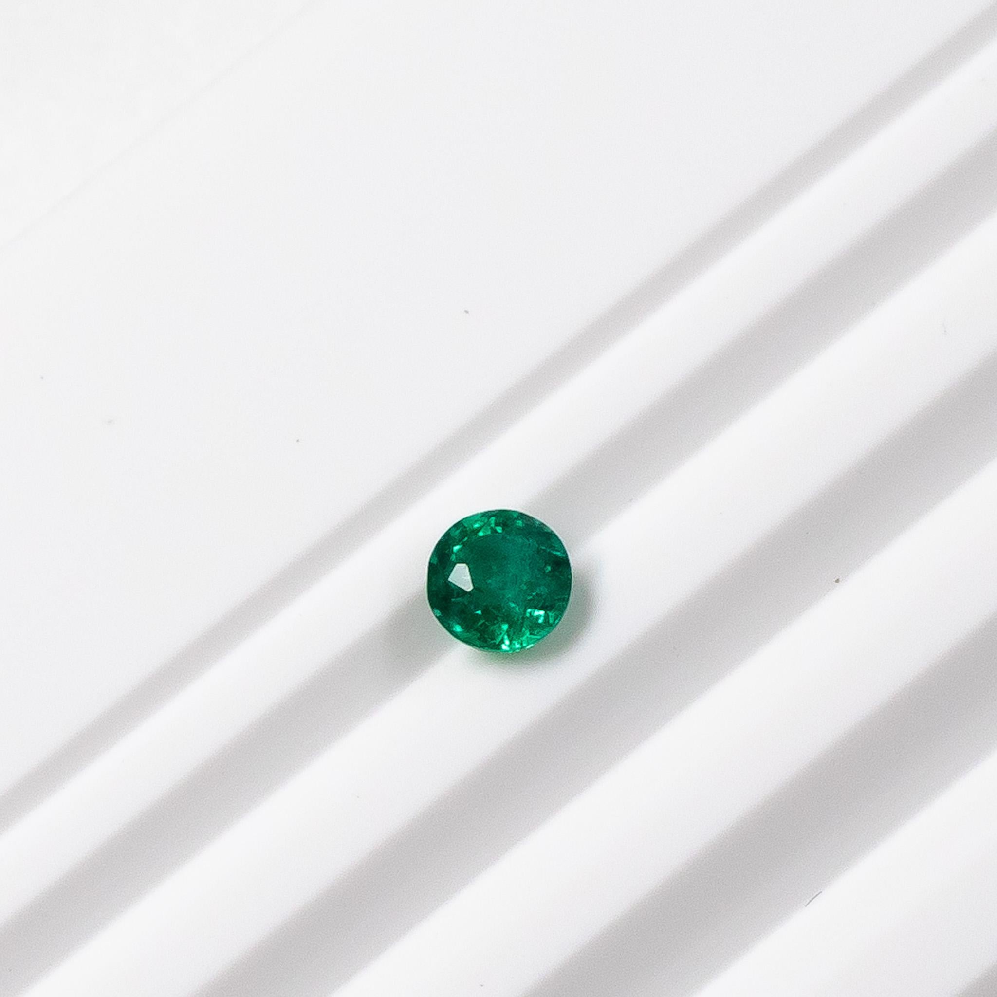 Beautiful round green emerald stud earring set in Platinum. 

The natural Zambian green emerald is a stunning medium blue-green colour. The stud is set in a three prong martini setting with a butterfly push back. Please note you are  purchasing one
