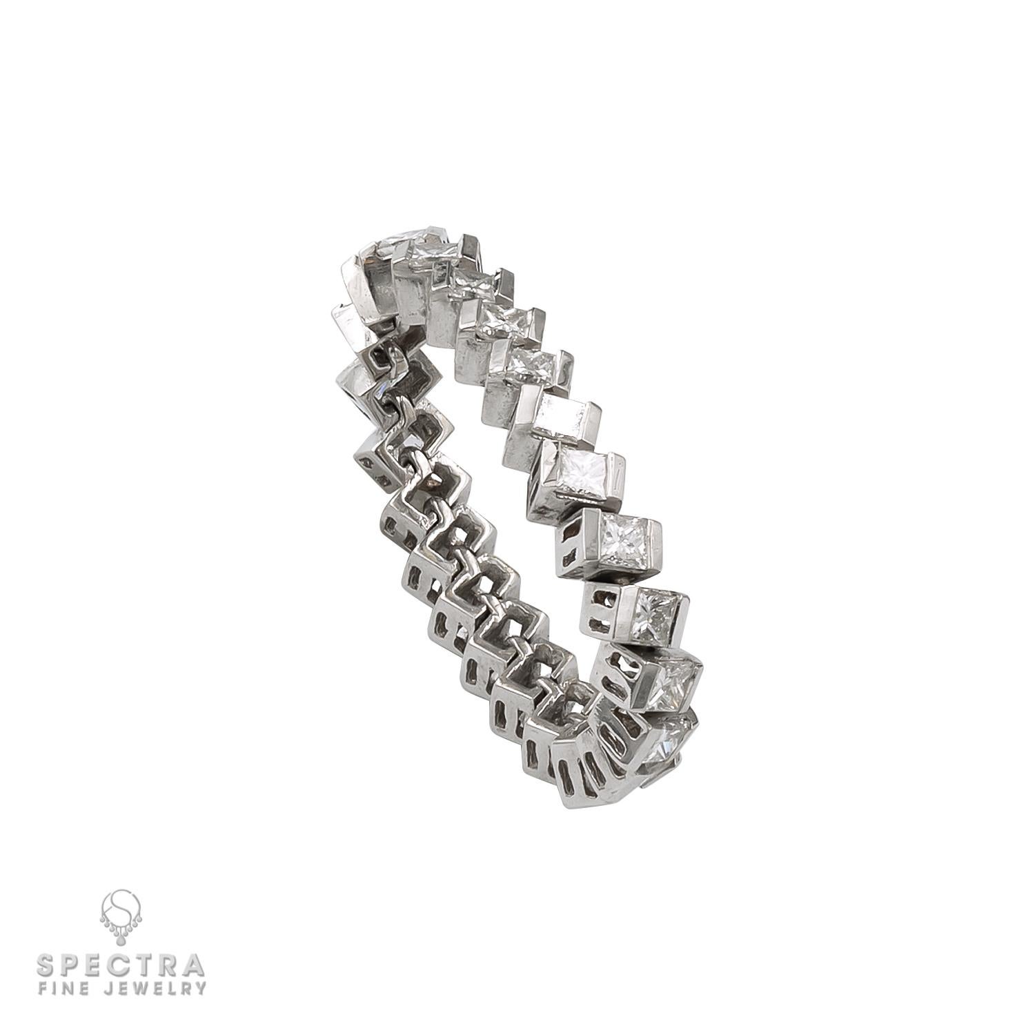 Behold the elegance of this 14k white gold ring, weighing 3.30 grams and adorned with a single row of enchanting princess-cut diamonds weighing approximately 2.0 carats total. Renowned for their brilliance, these diamonds are meticulously arranged