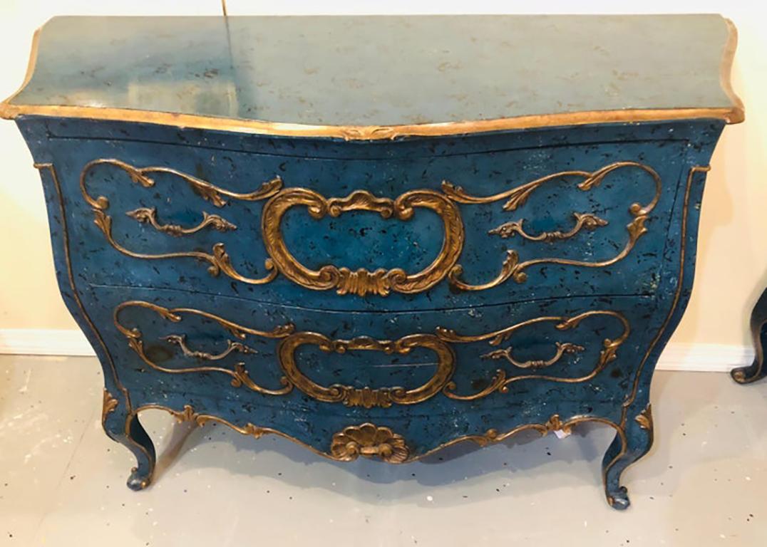 Royal blue and parcel-gilt decorated Bombay commode, nightstand or chest. This fine hand painted dramatic commode or chest are simply stunning done in the Bombay Louis XV style. This Hollywood Regency commode has a wonderfully carved chests with