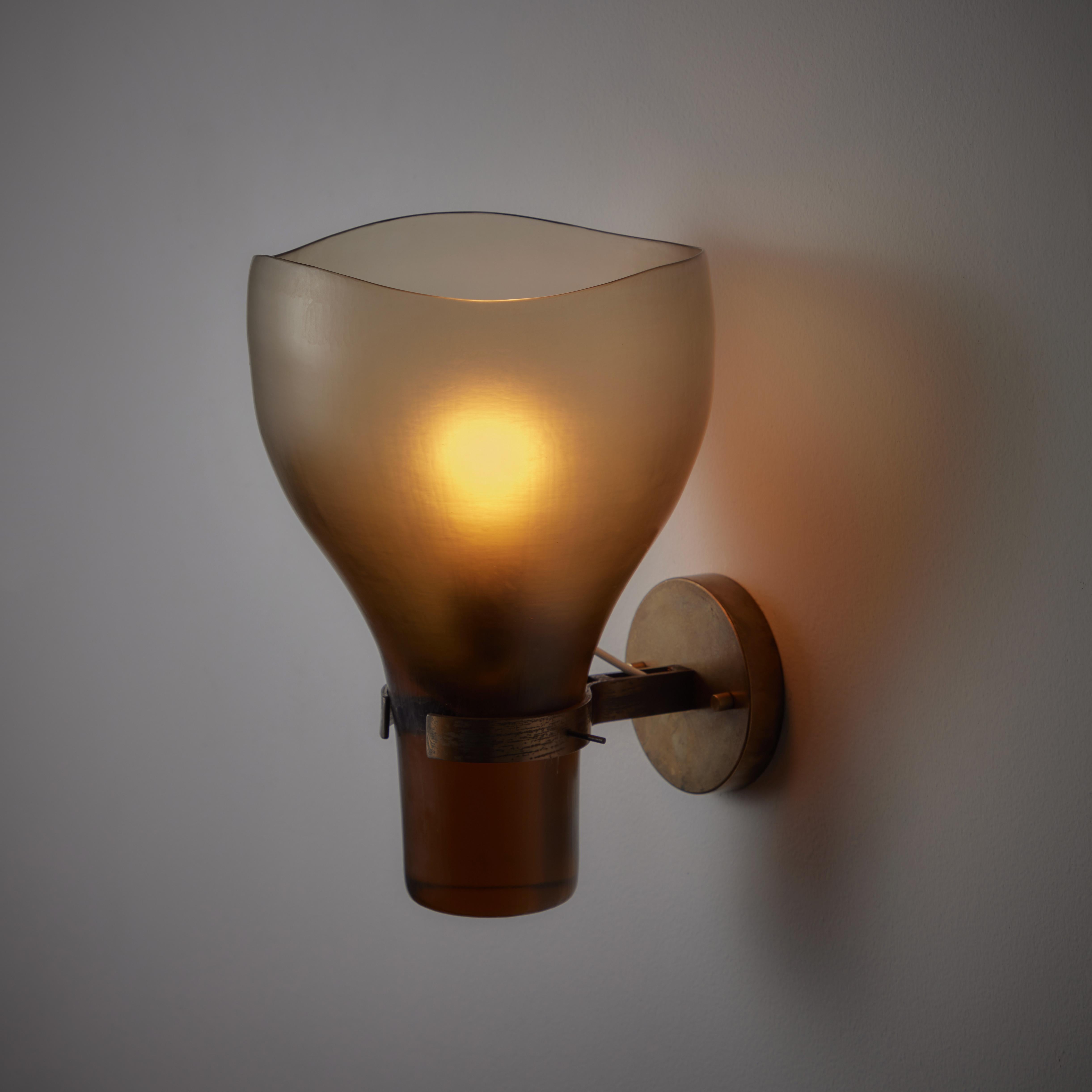 Single sconce by Tobia Scarpa for Venini. Rare battuto glass chalice shaped wall sconce in an ambient amber color. We recommend a 40w maximum E12 bulb. Wired for US Standards. Bulb not included. 

Literature: Franco Deboni, Venini Glass: Its