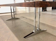 Single slab walnut dining table with mirror polished aluminum "Pi" legs