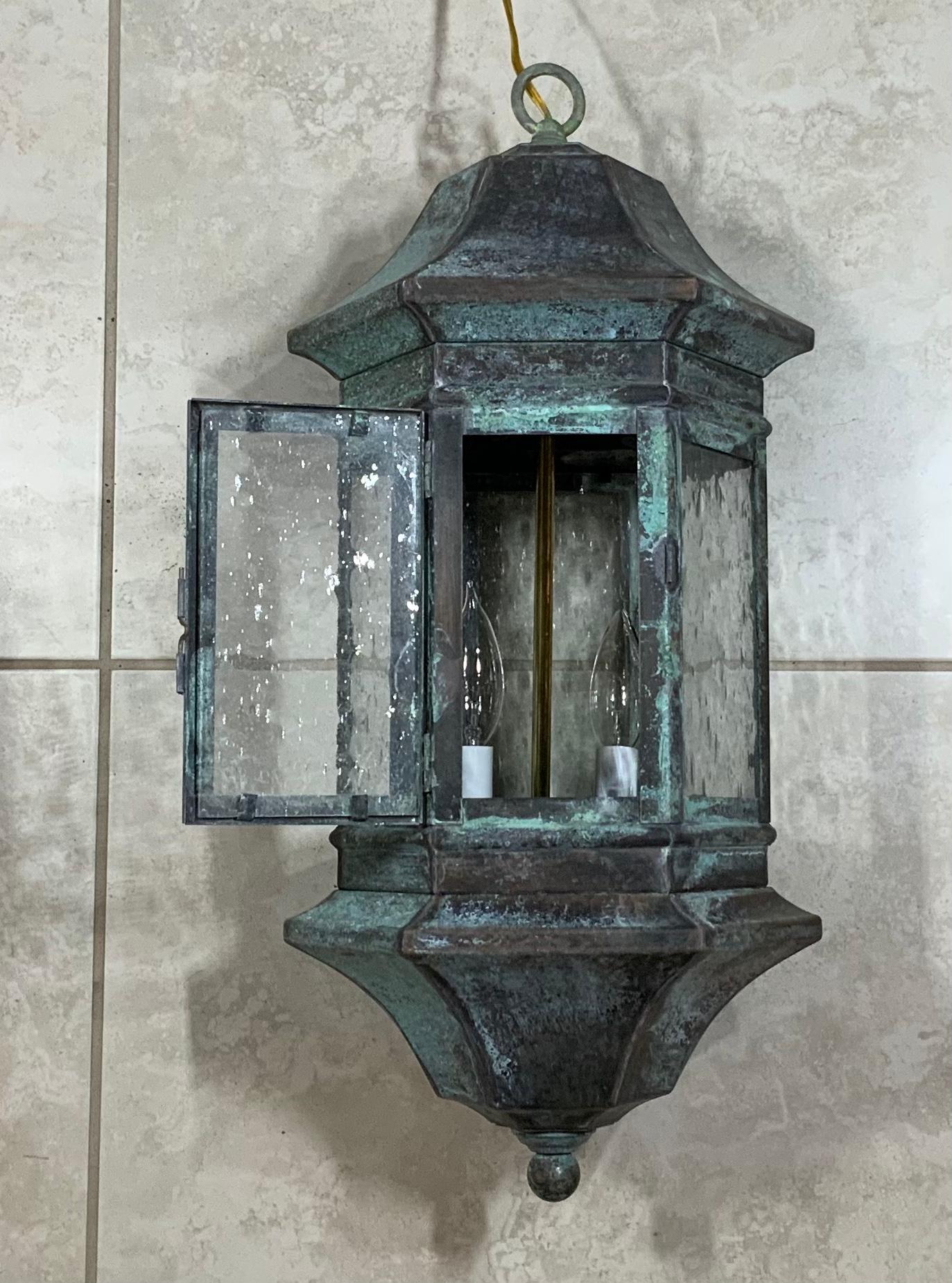 Hanging lantern made of solid brass, seeded frosty glass, originally it was wall lantern converted to hanging lantern or chandelier , re-electrified with new brass stem with two 60/watt lights suitable for wet location.
Beautiful patina, and ready