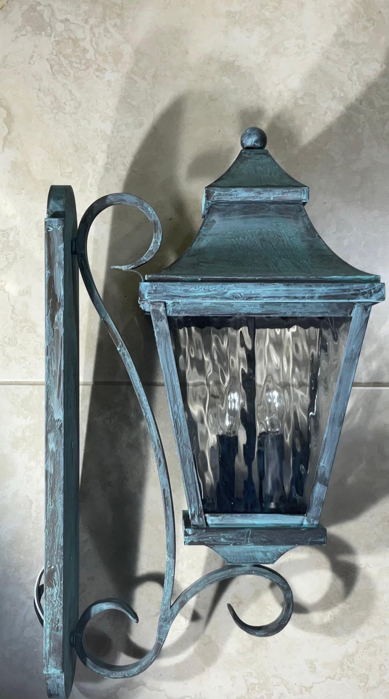 

Elevate Your Space with Timeless Charm.
These exquisite single solid brass wall hanging lantern will add a touch of classic elegance to any space. Crafted from high-quality brass ,art glass ,and finished in a beautiful patina, this lantern exude