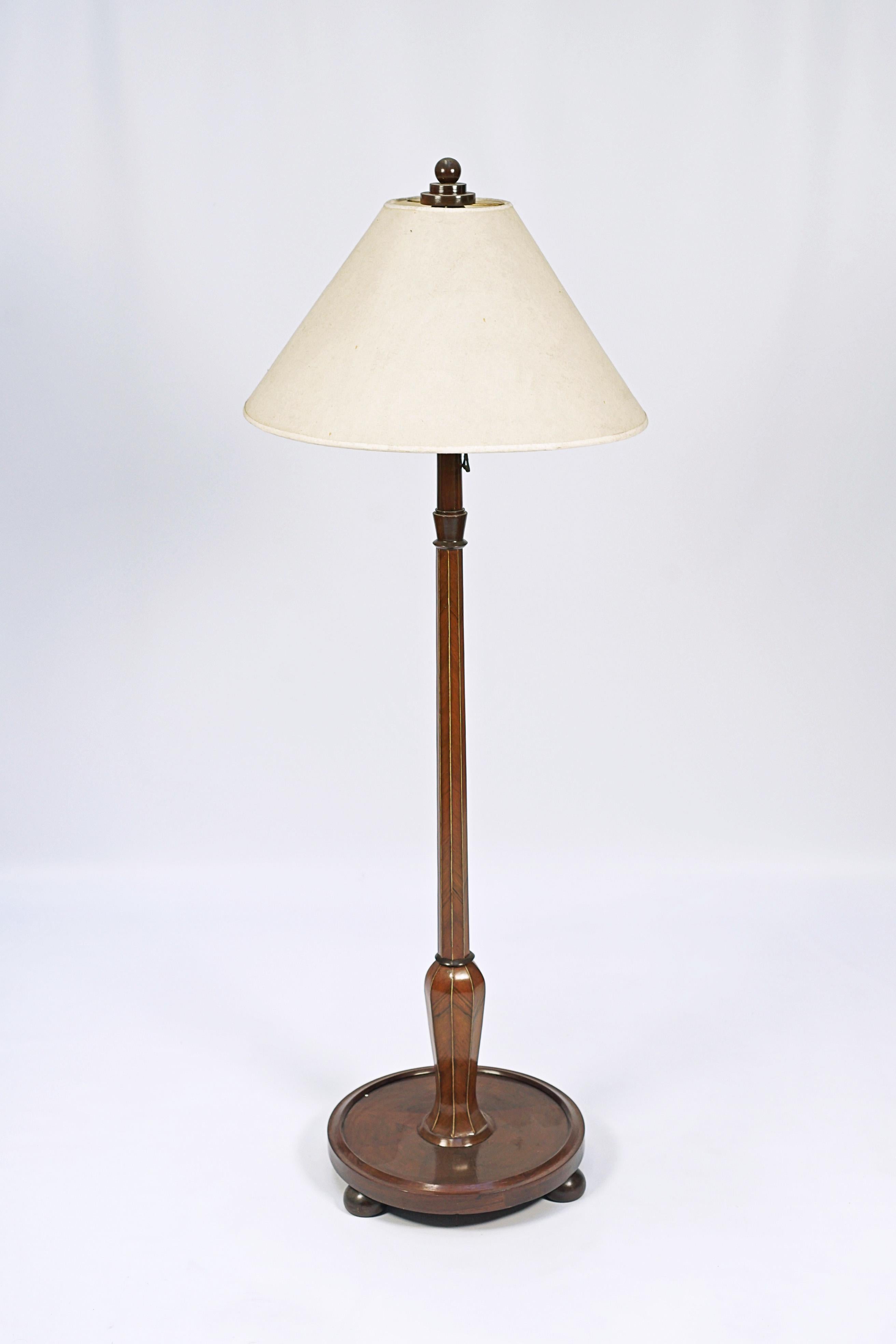 Single standing lamp designed by Jules Leleu (1883-1961). Wood with inlays and cloth shade, the lamp has the original switch.

France, CIRCA 1920.