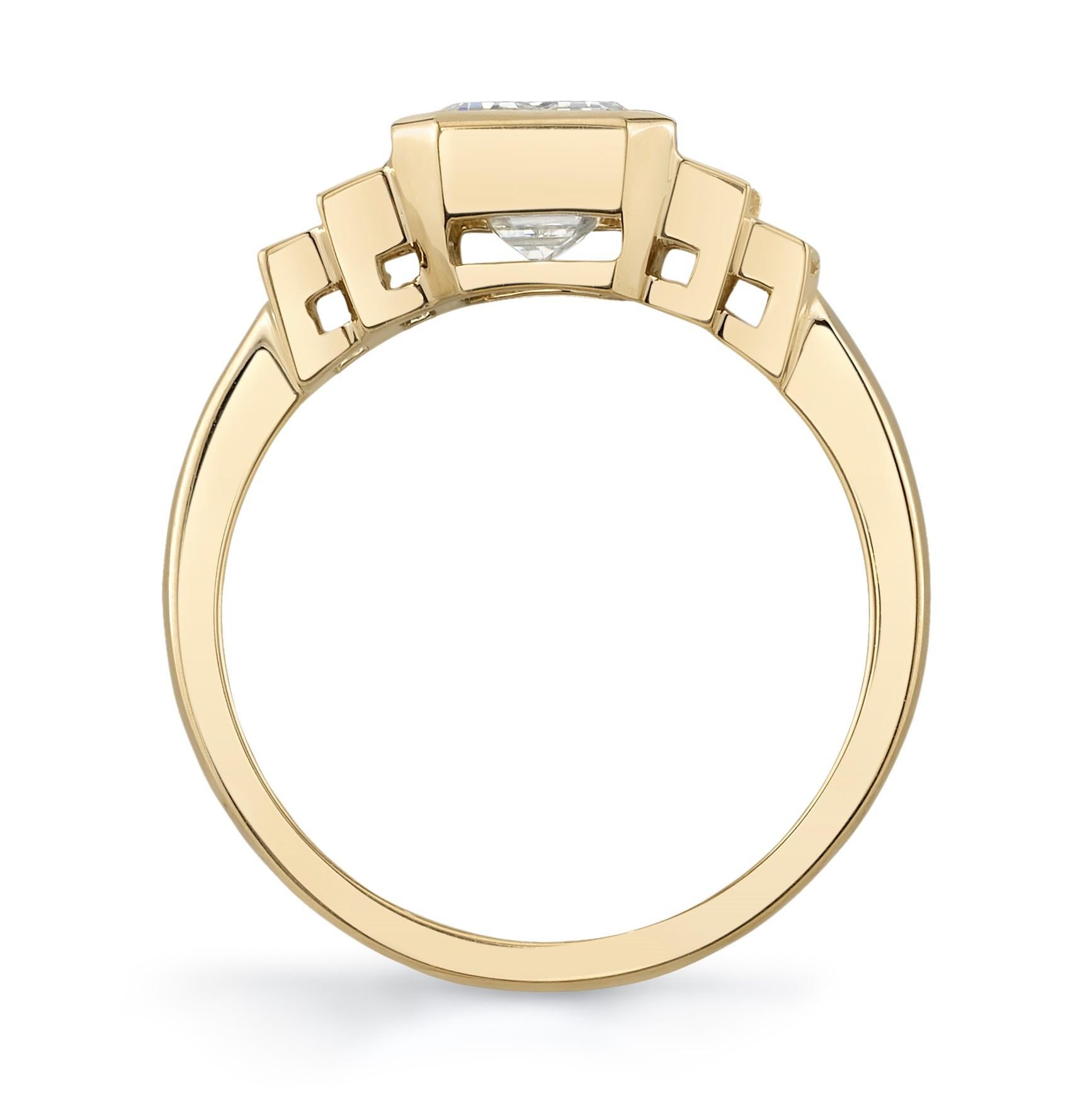 From designer Single Stone, Caroline 18 karat yellow gold diamond engagement ring. This ring is crafted with a 3.32 carat bezel set emerald cut diamond with L color and VVS2 clarity. Additionally, this ring features 4 bezel set baguette cut diamonds