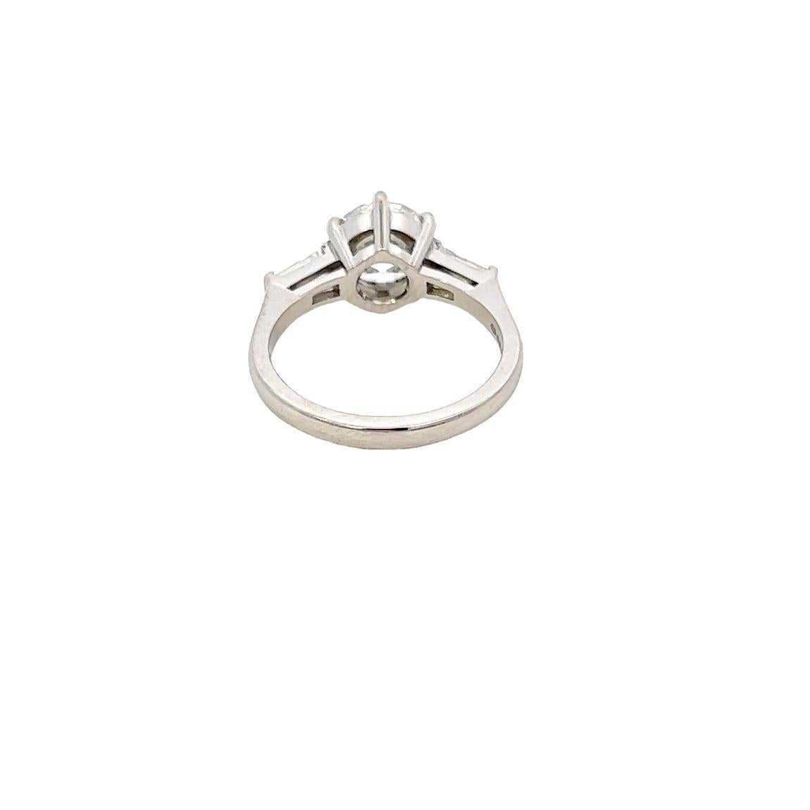 Contemporary Single Stone Diamond Engagement Ring with Tapered Baguette Diamond Shoulders For Sale