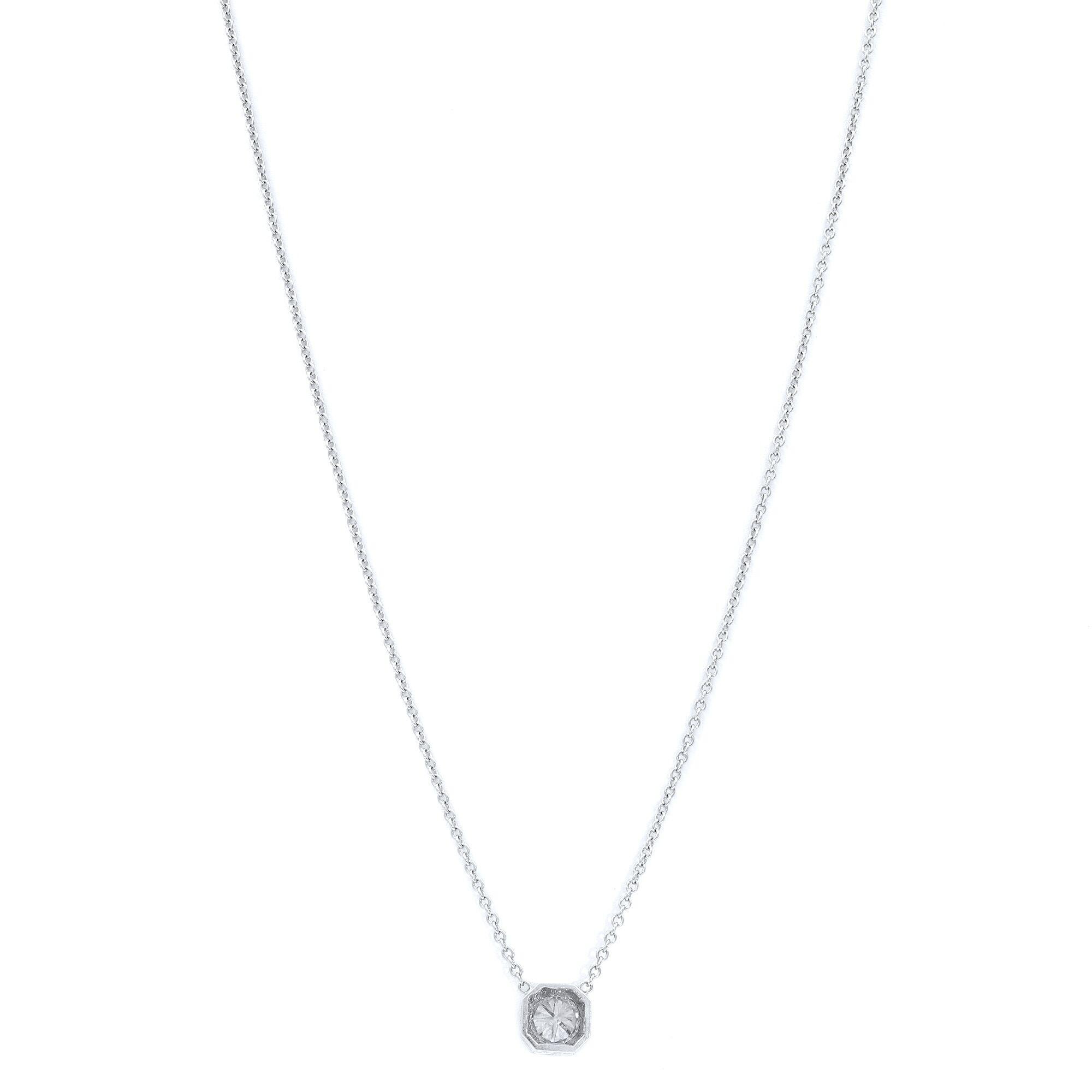 18 karat white gold diamond pendant consisting of one round brilliant cut diamond weighing 1.00 precisely and having a color and clarity grade of near colorless VS1, prong set in an engraved octagon shaped pendant.

Length: 17 inches.