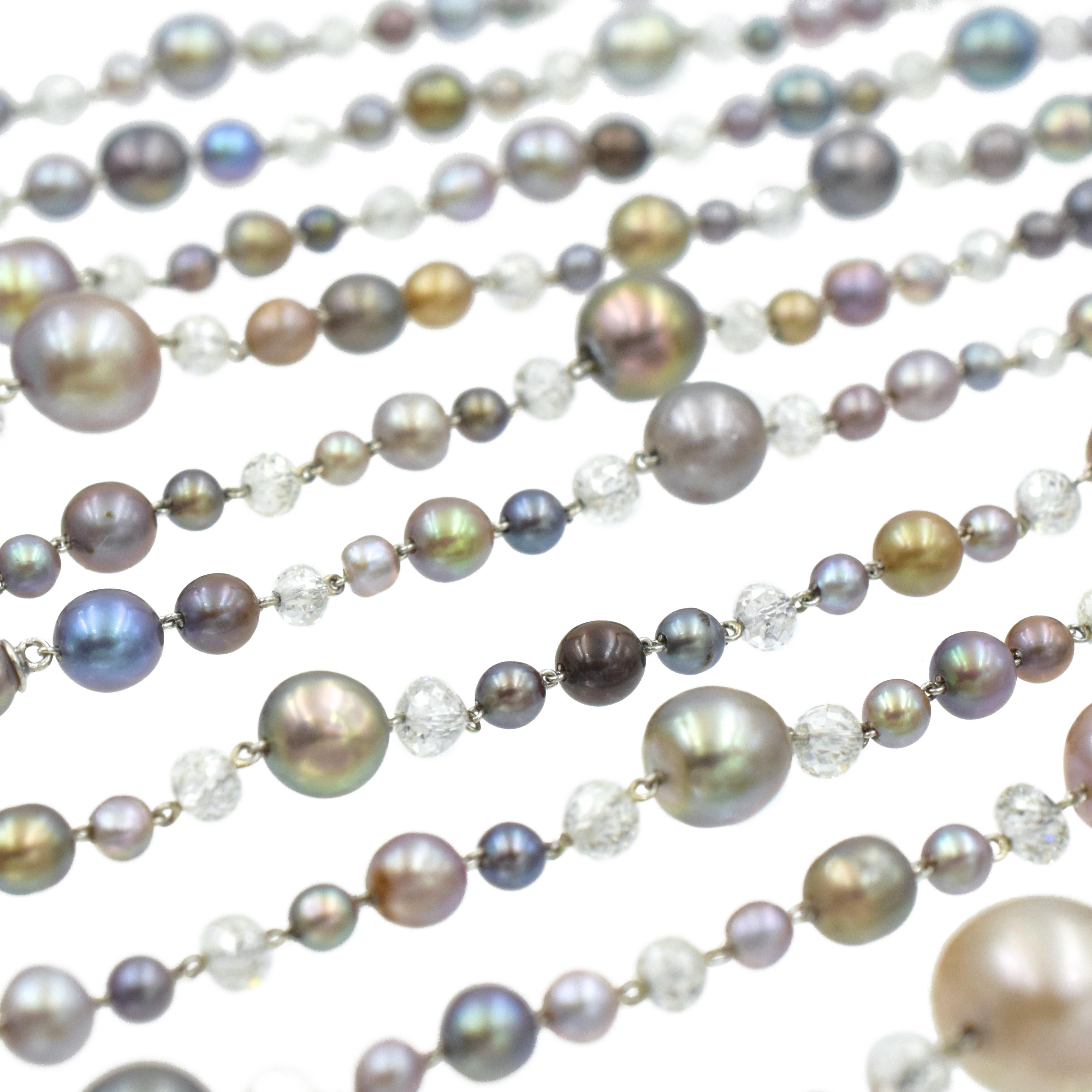 Single-Strand Natural Pearl And Diamond Necklace. This necklace consists of two-hundred-fortyseven
natural pearls measuring from 9.36mm to 2.94mm in diameter. The pearls are round, near round, and slightly baroque of various gray, green, pink and