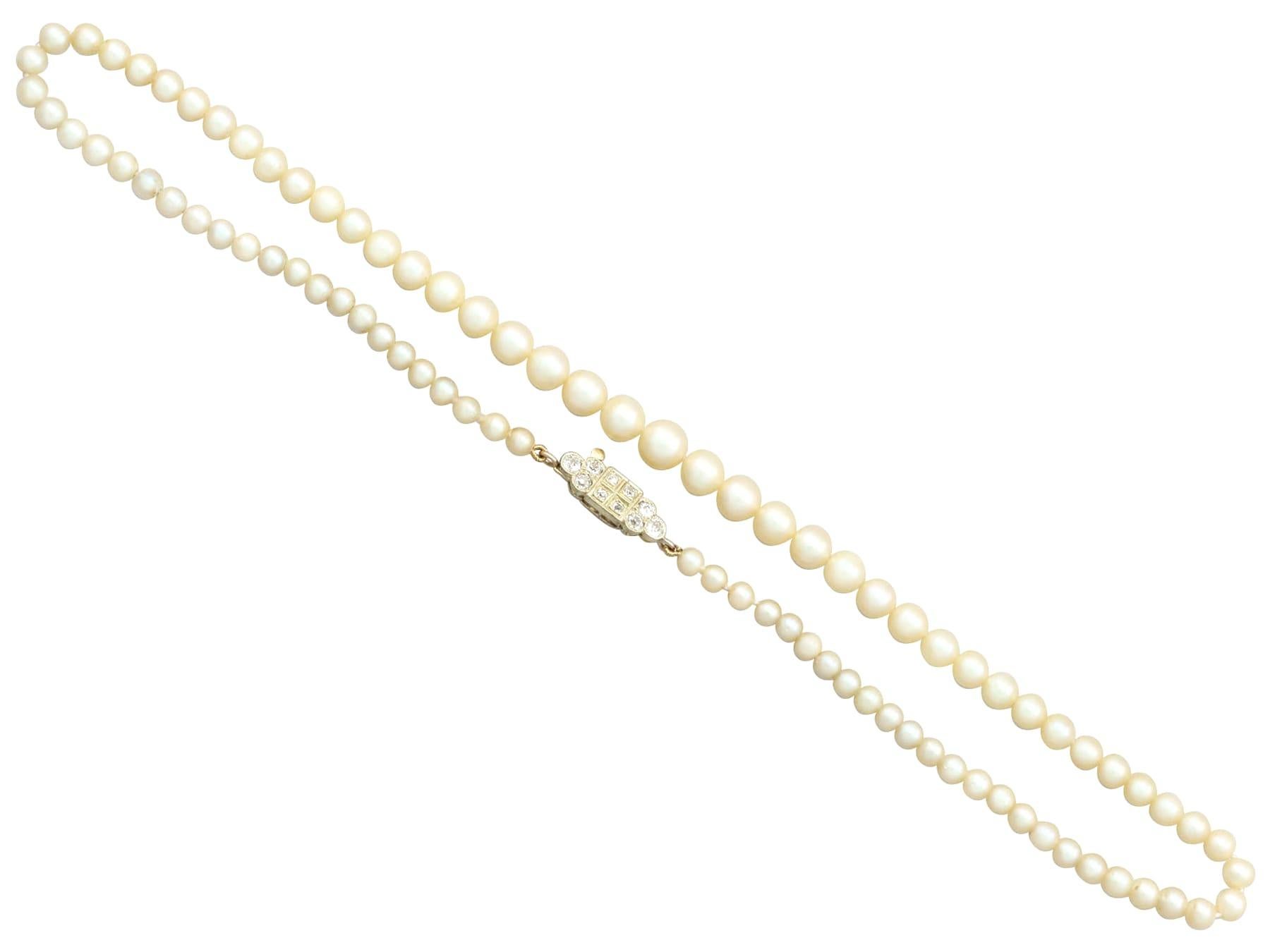 An impressive single strand cultured pearl necklace with 0.56 Ct diamond and 15k yellow gold clasp; part of our diverse antique jewelry and estate jewelry collections.

This fine and impressive single strand pearl necklace with diamond clasp has