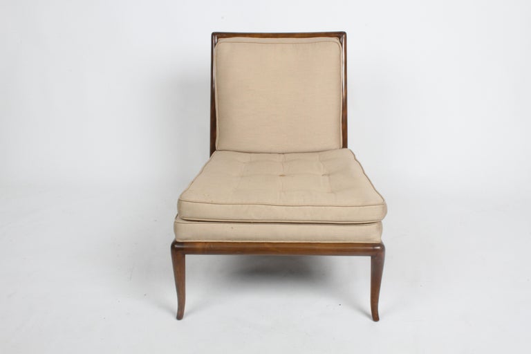 Beautiful design by T. H Robsjohn-Gibbings in original finish, with older silk upholstery. Elegant splayed legs on walnut frame, original finish shows minor scuffs. Upholstery shows stains, needs to be updated. From one owner estate, no label, home