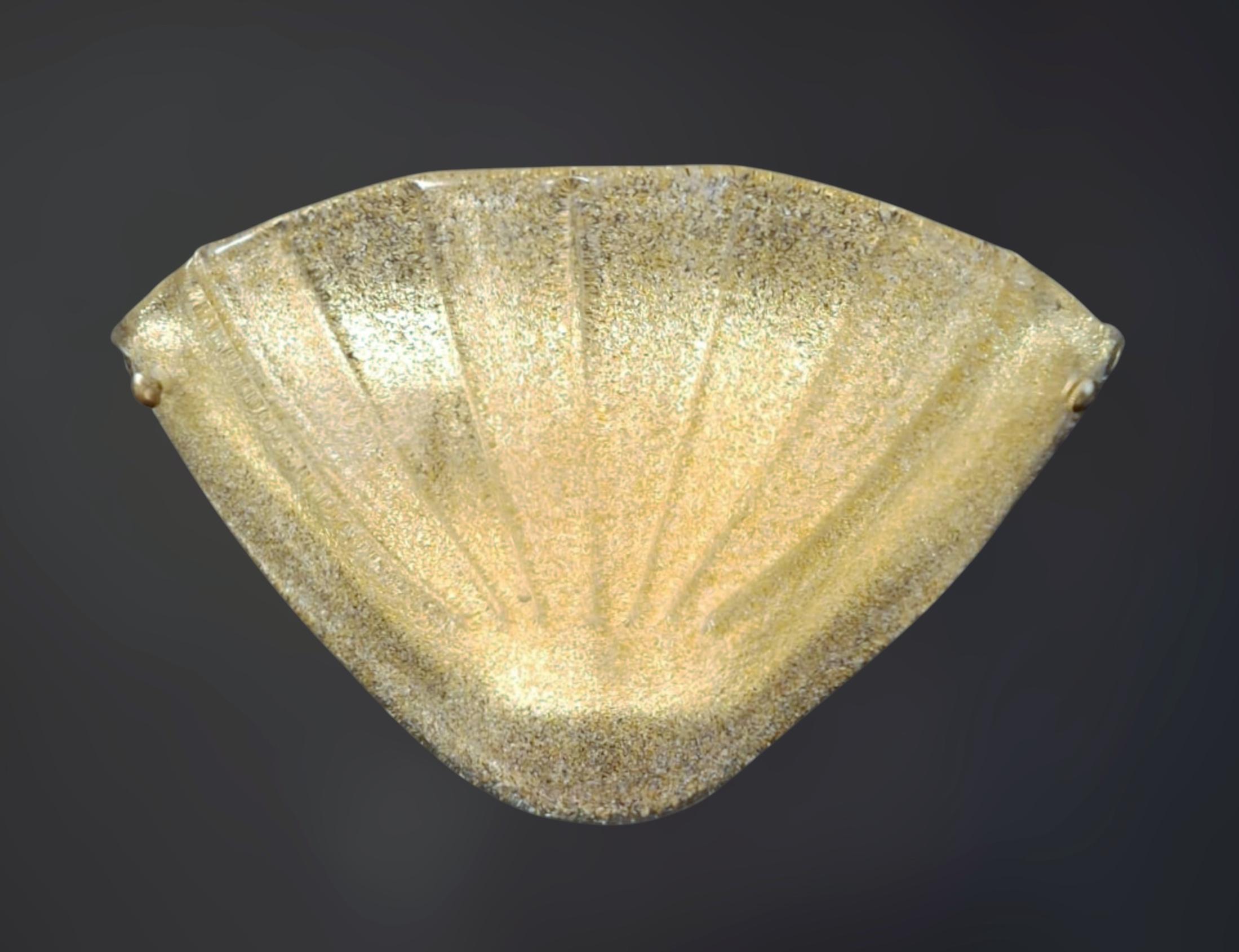 Vintage Italian Murano glass uplight sconce hand blown with amber graniglia technique to produce granular textured effect, mounted on brass frame / Made in Italy, circa 1960s
Measures: width 13.5 inches / Height 7 inches / Depth 5 inches
1 light /