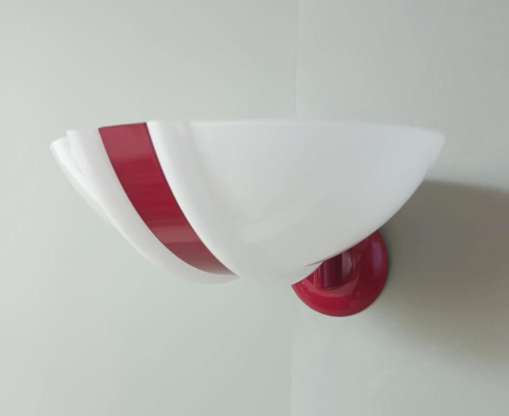 Vintage Italian wall light with a milky white Murano glass shade and a red metal stripe in the middle / made in Italy in the style of Stilnovo, circa 1980s
Measures: height 5.5 inches, width 10 inches, depth 12 inches
1 light / E12 or E14 type / max