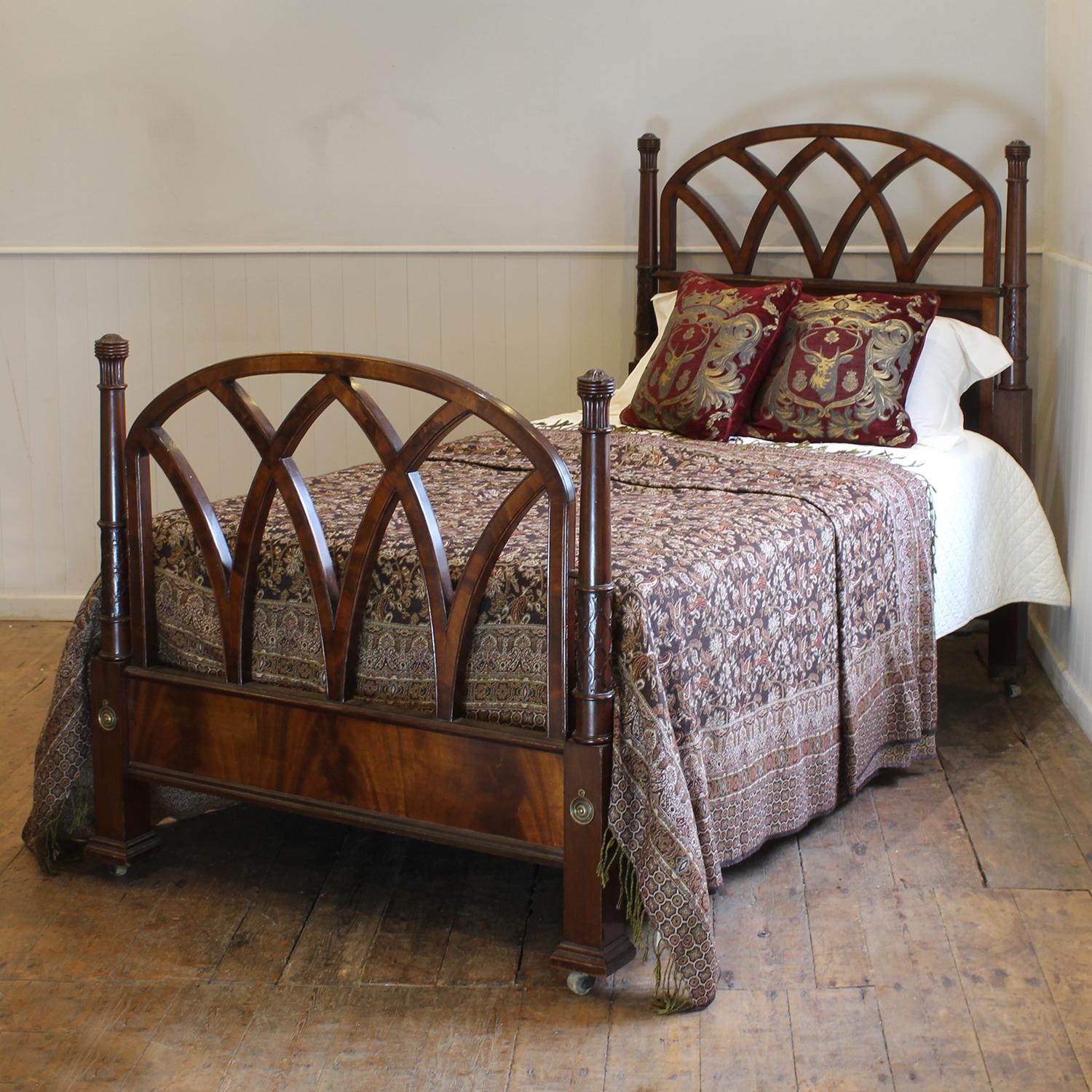 A Gothic style Victorian bed with open arched panels and tall carved posts.

This bed accepts a larg single 42