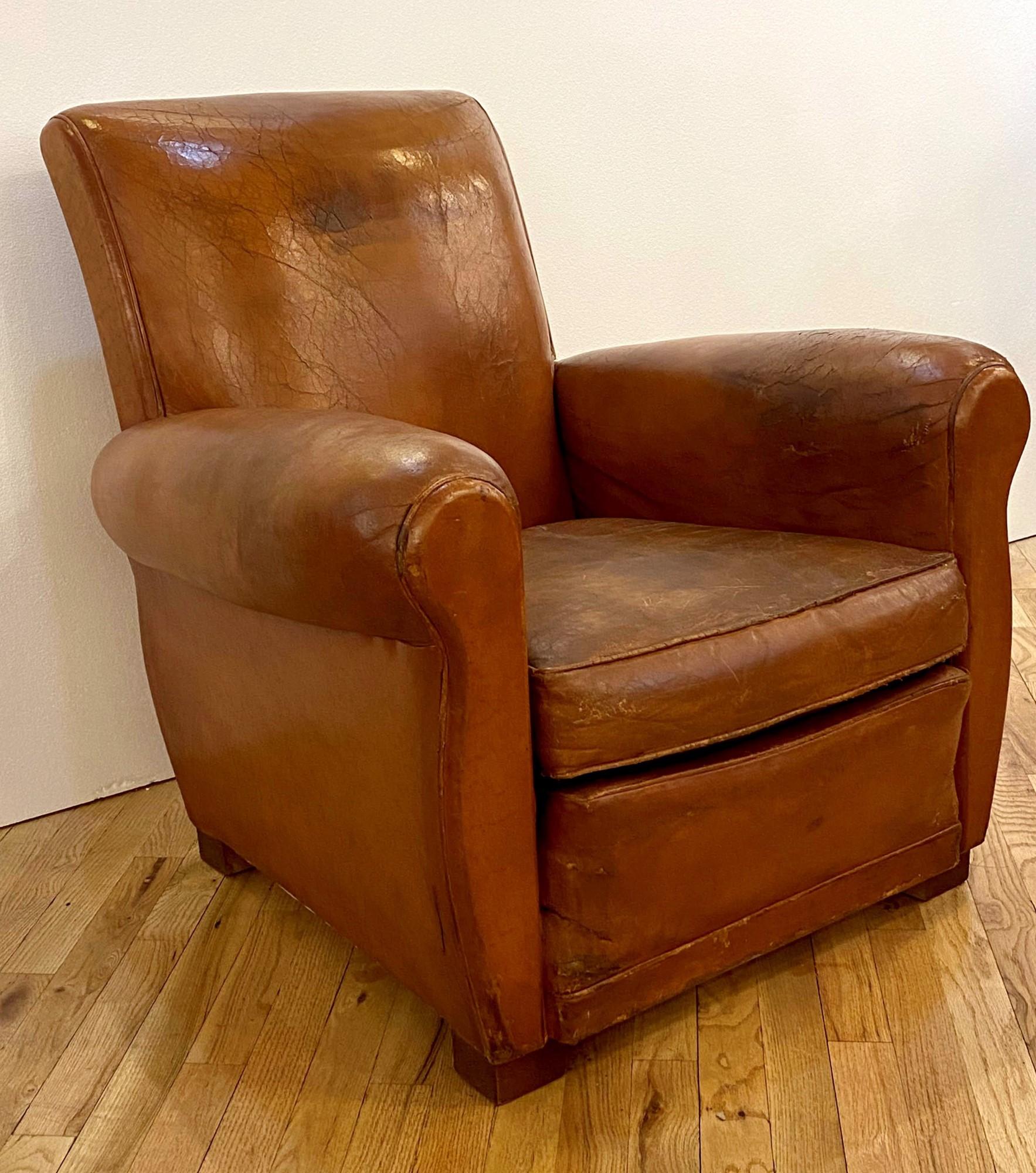 Vintage Art Deco French leather club chair. This chair has been refurbished and has only minor wear and cracking. One available. This can be seen at our 333 West 52nd St location in the Theater District West of Manhattan.