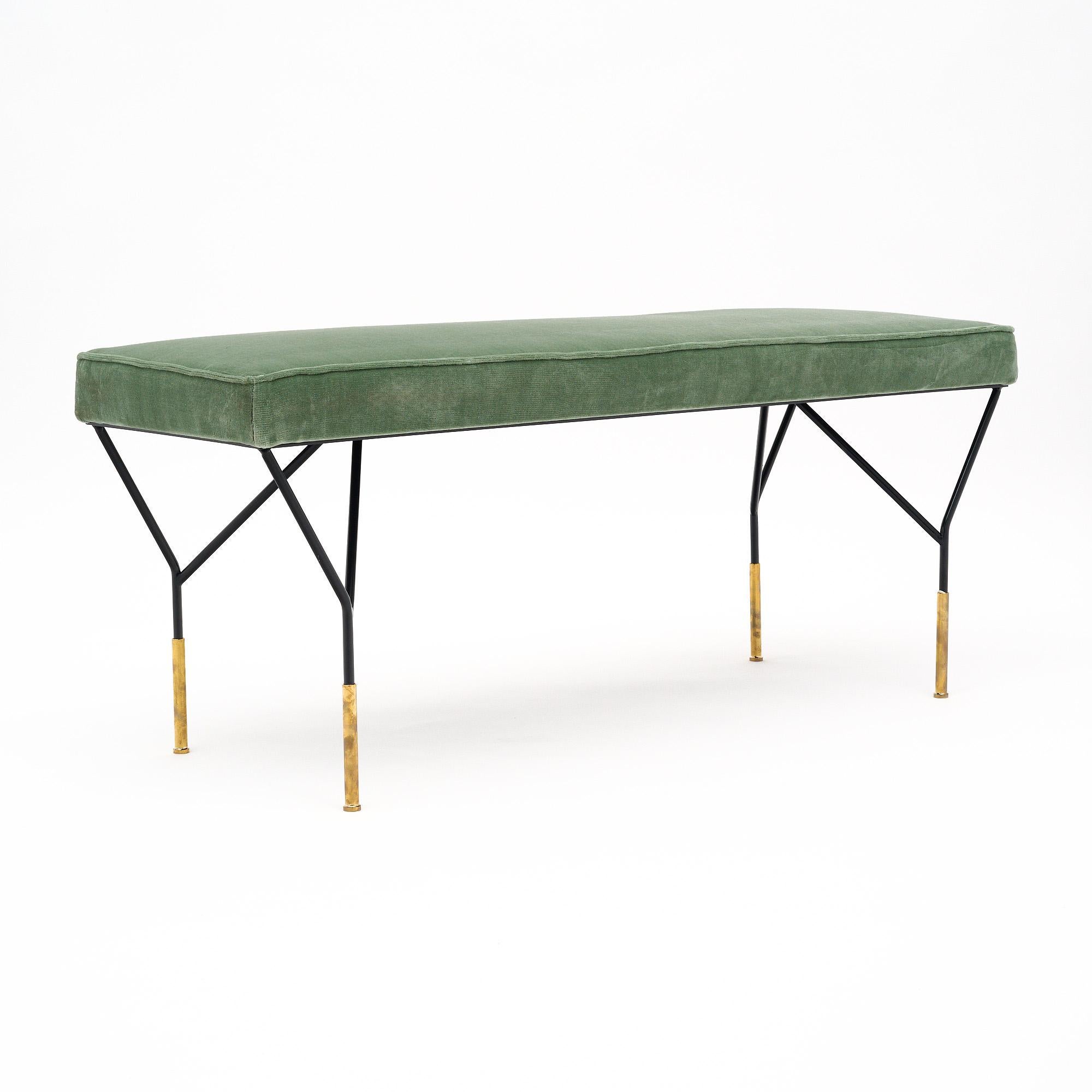 A dynamic bench in the style of Carlo di Carli. This piece features the black lacquered steel base with gilt brass feet so iconic of the designer. It is newly upholstered in a sage green velvet fabric.
