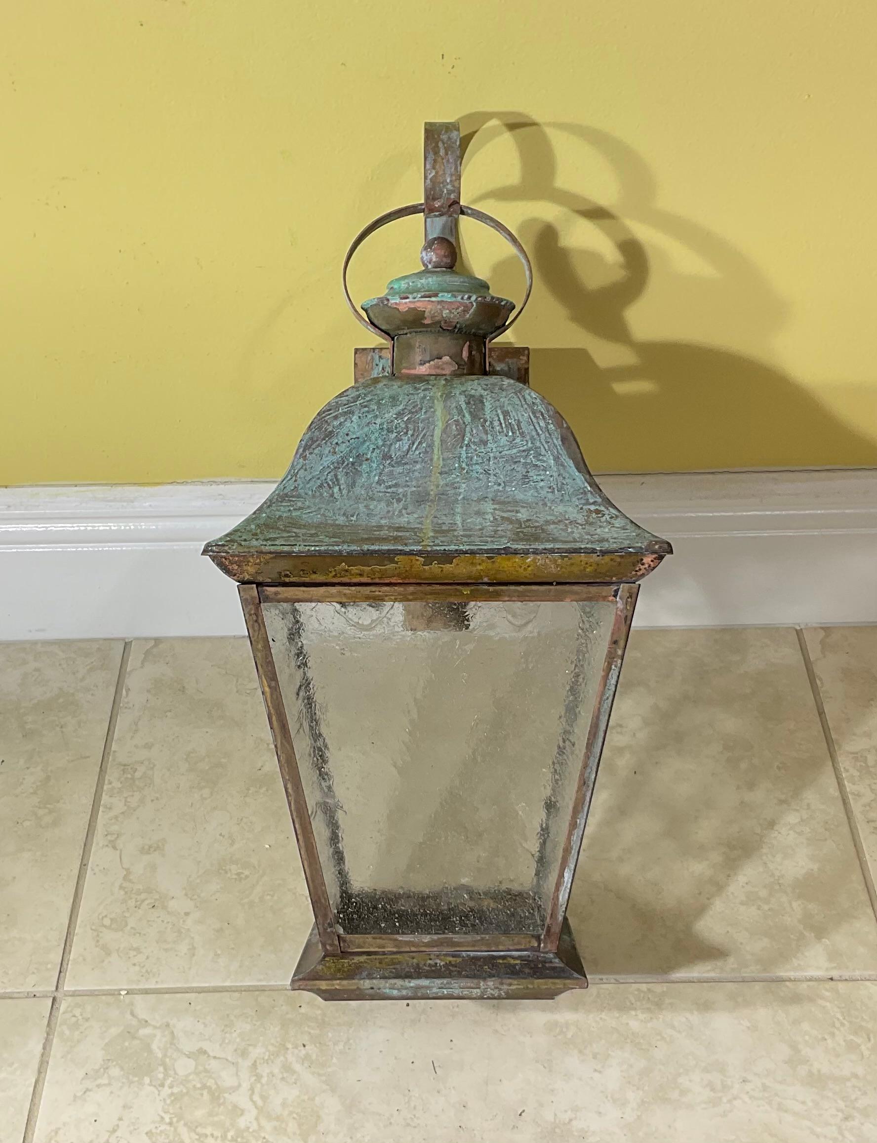Elegant single wall lantern ,hand crafted from solid brass with one 60/watt light ,  four sides of textured glass. Beautiful patina.
 Suitable for wet locations, electrified and ready to use.
decorative lantern indoor or outdoor.