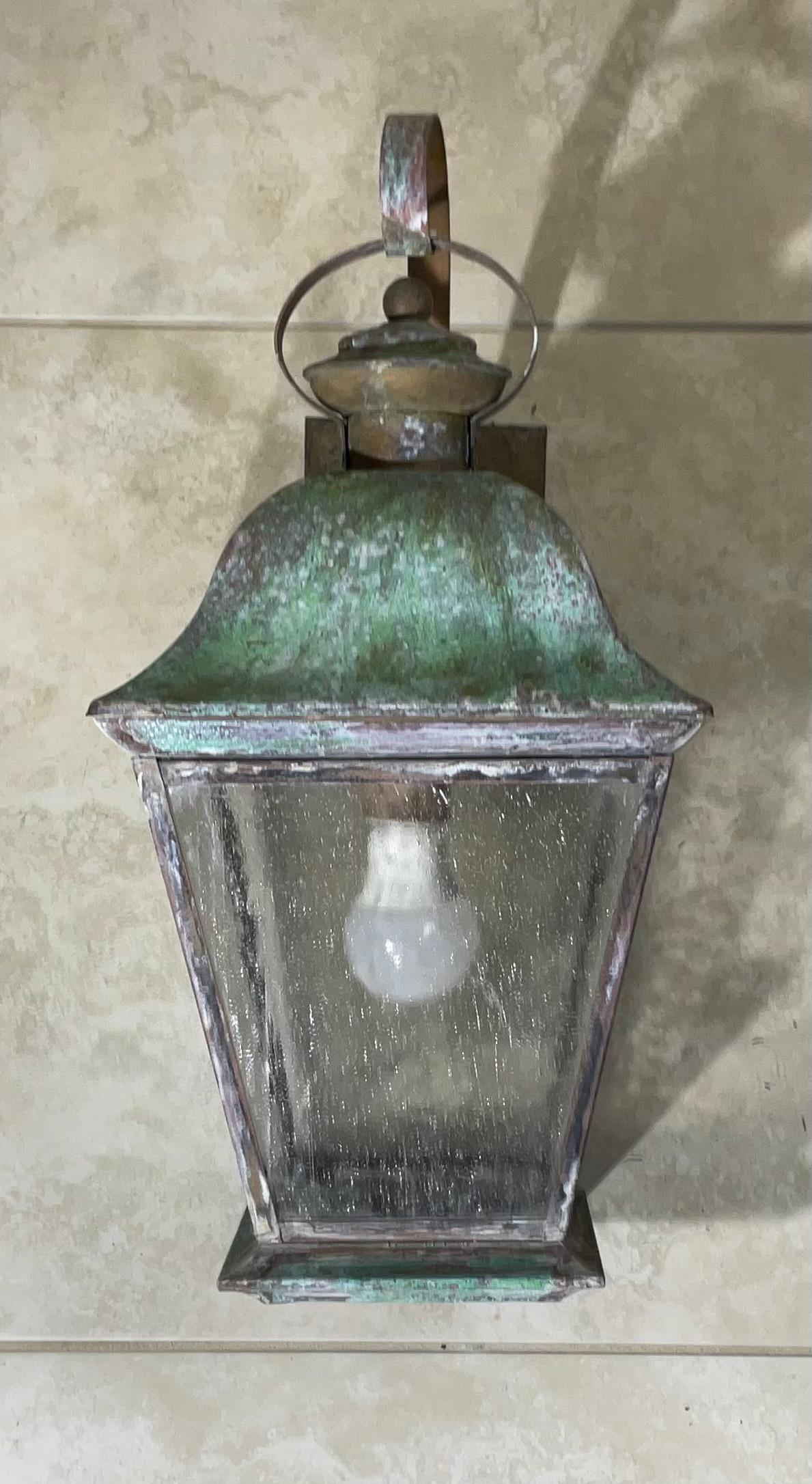 Elegant single wall lantern ,hand crafted from solid brass with one 60/watt light ,  four sides of textured glass. Beautiful patina.
 Suitable for wet locations, electrified and ready to use.
decorative lantern indoor or outdoor.