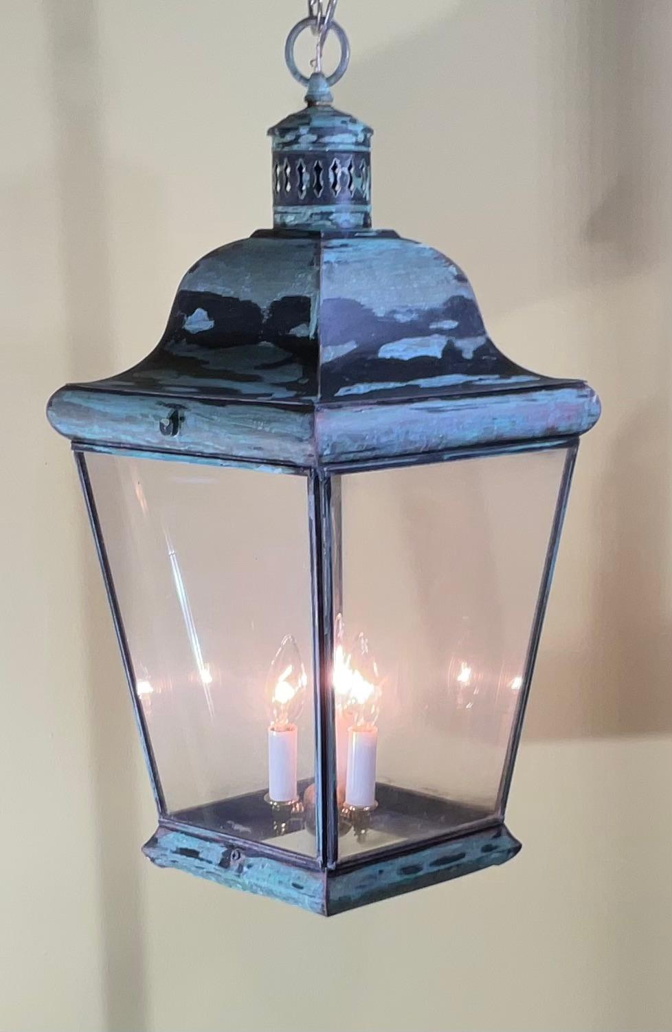 elegant hanging lantern made of solid brass, with three 40/watt lights 
Original clear acrylic sides.
Very nice patina 
New Canopy and chain included.

