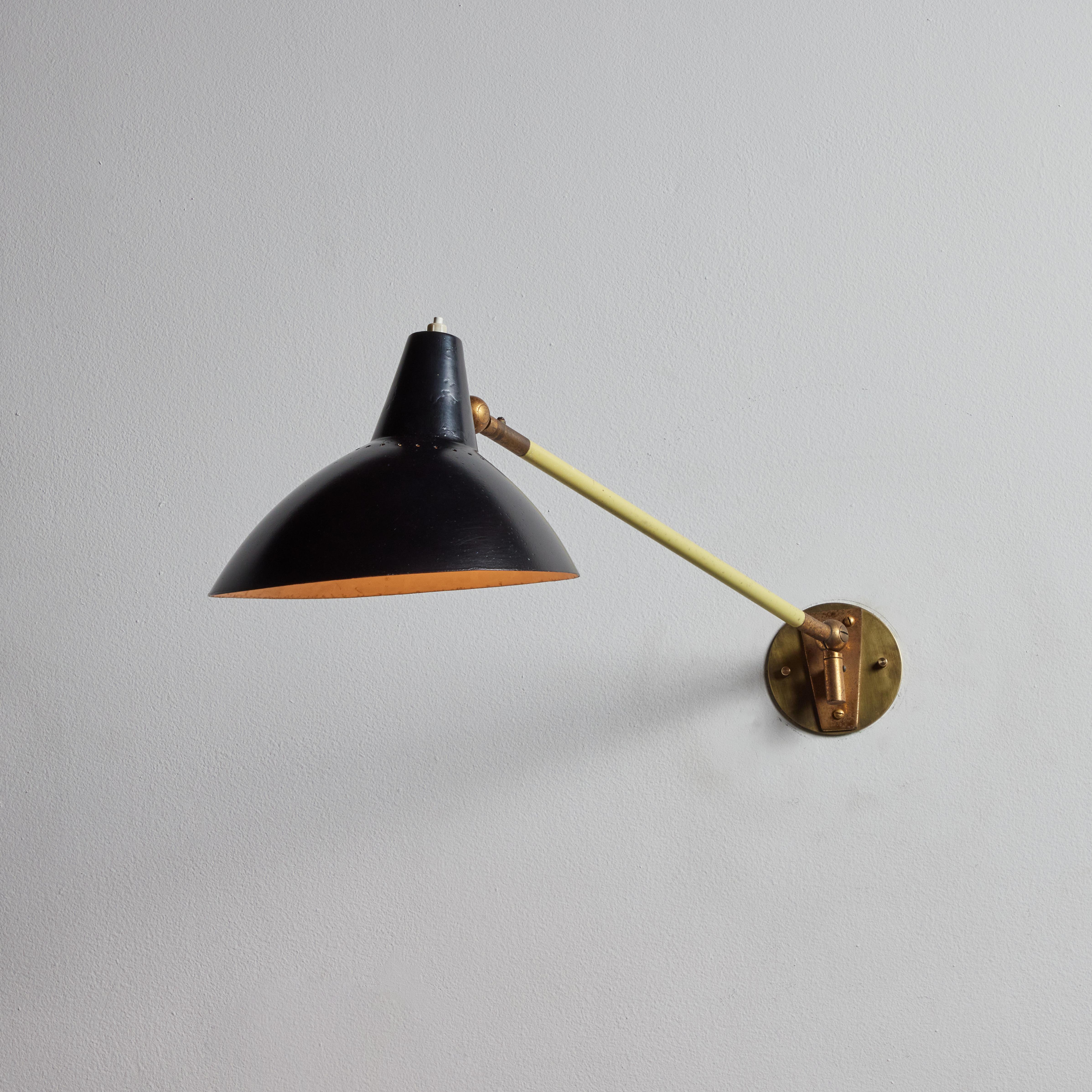 Single wall light by Stilnovo. Manufactured in Italy, circa 1950's. Enameled metal, brass. Rewired for U.S. standards. Shade adjust to various positions, arm adjust up/down. We recommend one E27 75w maximum bulb. Bulbs provided as a one time