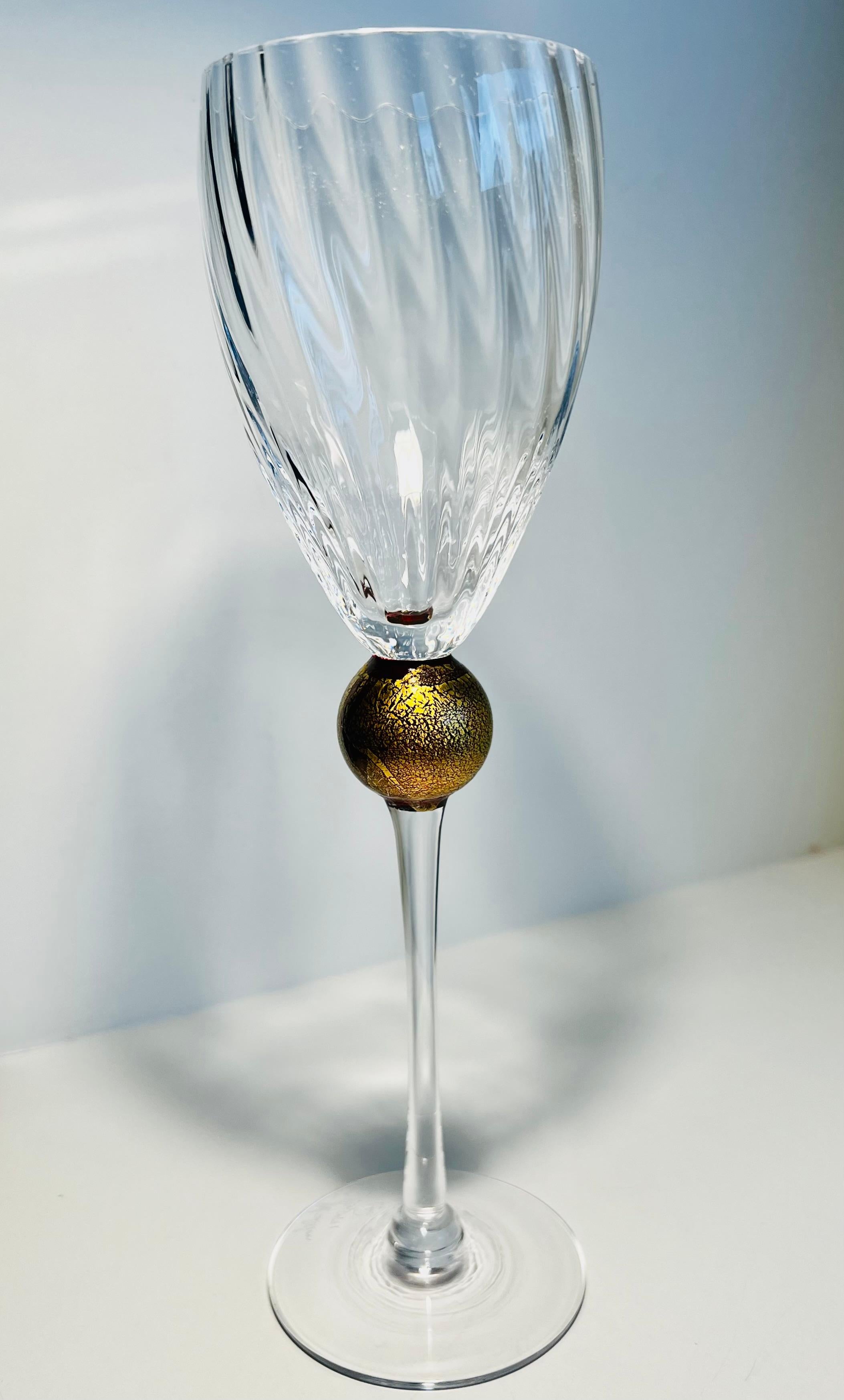 This single wine glass is by Union Street Glass part of the “Manhattan Collection”.
Each piece is handcrafted and unique.  The clear glass optic bowl rests on a 24 carat gold leafed ball.  The bowl rim is cut and polished.  The foot is signed on the