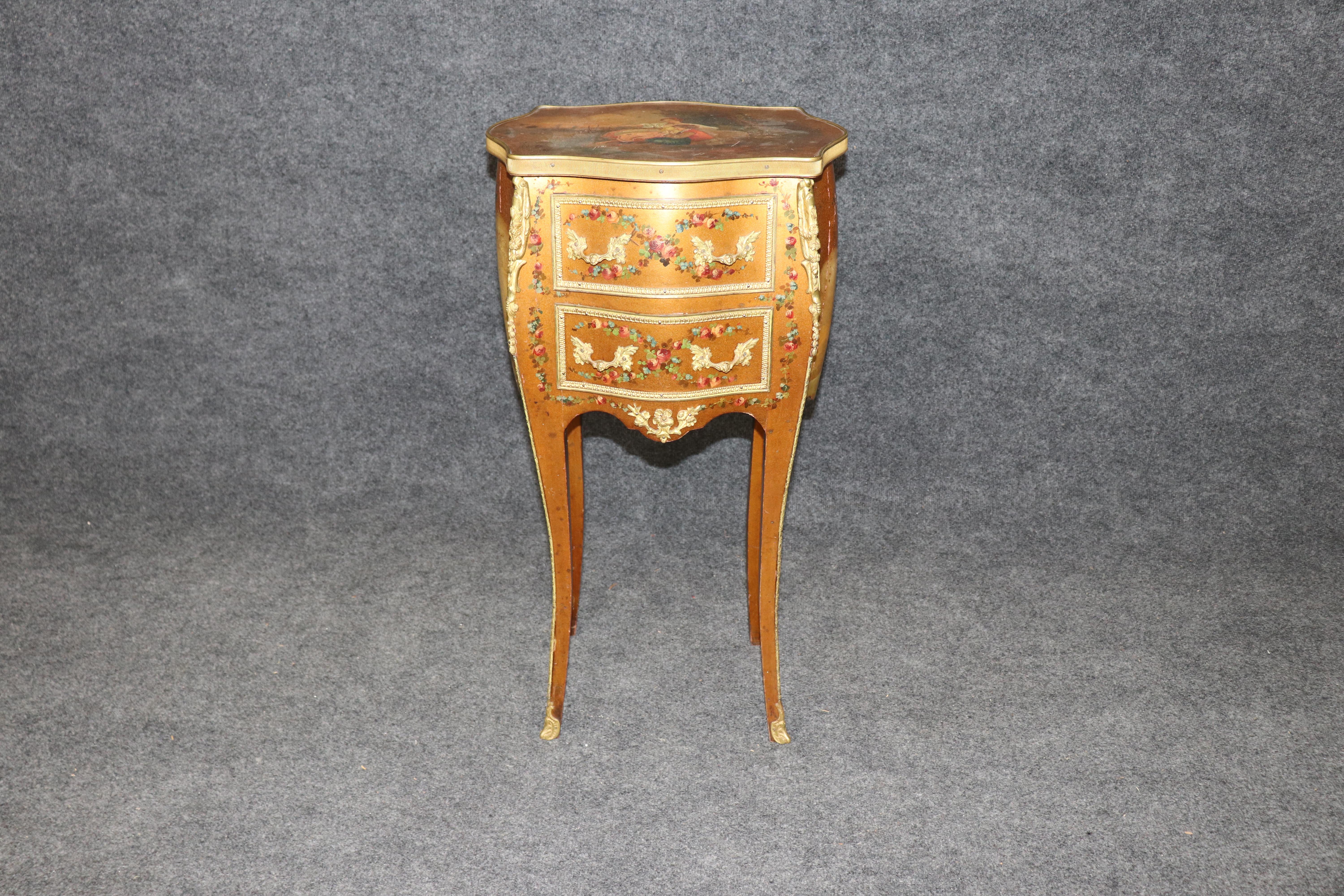 This is a fantastic Vernis Martin courtship scene painted night stand. The stand is from the early 1900s and beautifully gilded and painted. The brass adds a more elegant touch. The piece will show minor age cracks and signs of use but