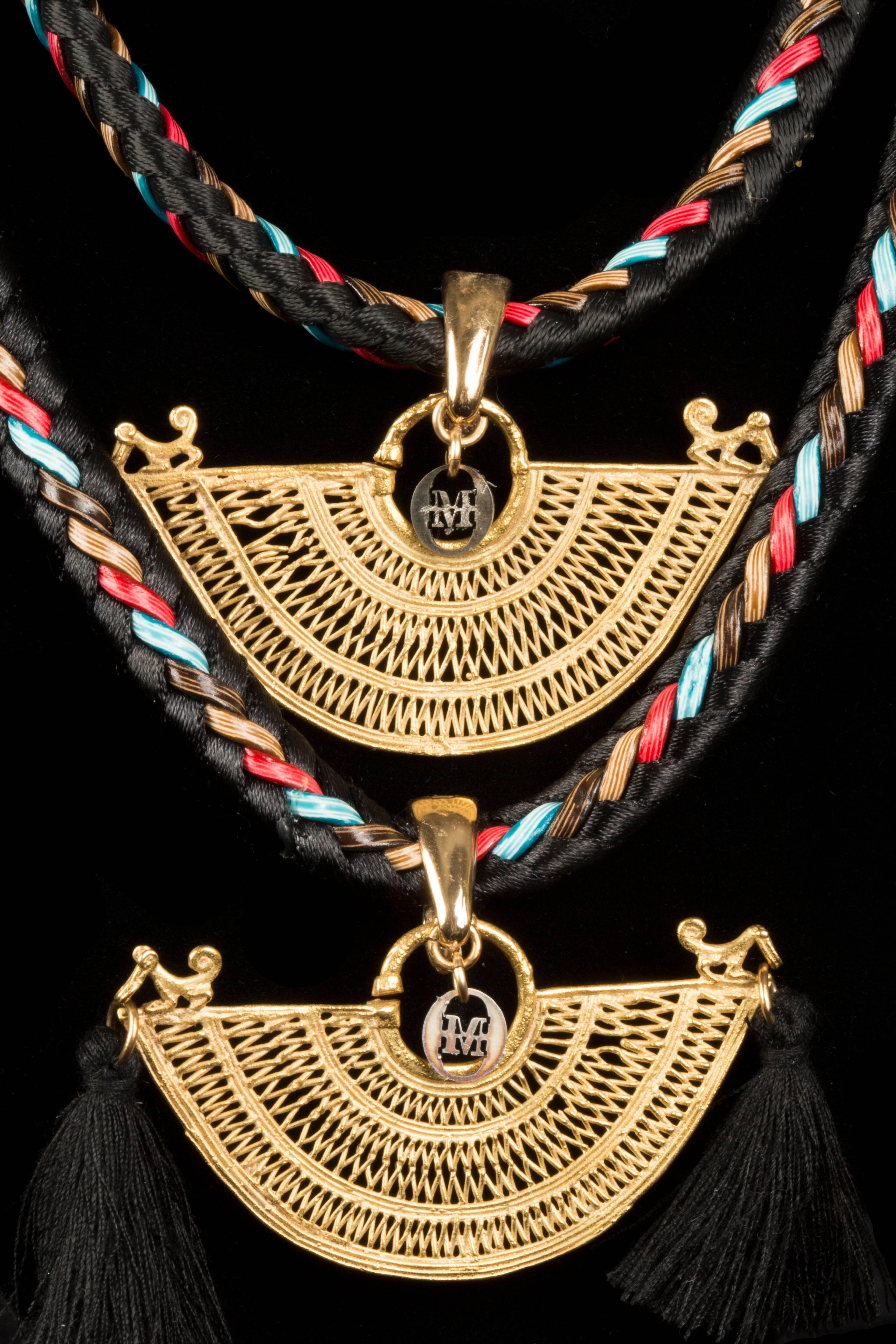 This double stranded necklace creates a cascade of pre-columbian gold from the Sinu Culture in Colombia. These intricate works were worn as earrings by the natives nearly 1,000 years ago.  They have been reworked with a modern design. Modern new