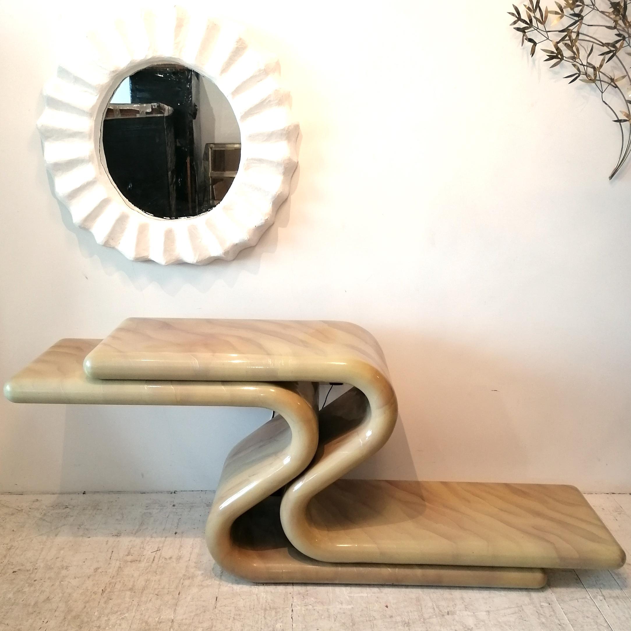 Incredible sinuous postmodern lacquered console table, Karl Springer / Jay Spectre style, 1980s American. It's deep cream, with subtle pinky mauve & silver marbling.
Condition is good, just a few little scrapes at corners, and small dings here and